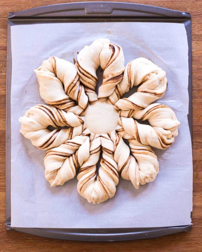 uncooked Cinnamon Star Bread on a parchment lined sheet pan