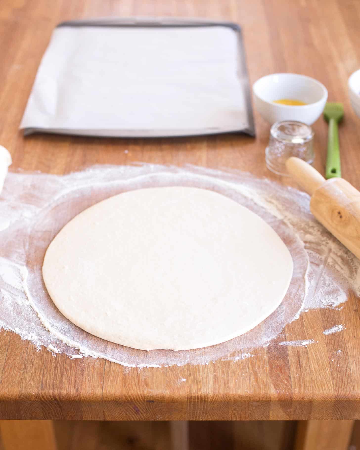 rolling dough out into circles on a floured surface