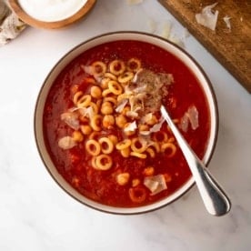 tomato soup with chickpeas and annelini pasta in tomato soup with a spoon