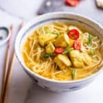 Thai Curry Noodle Soup with Chicken in a white bowl