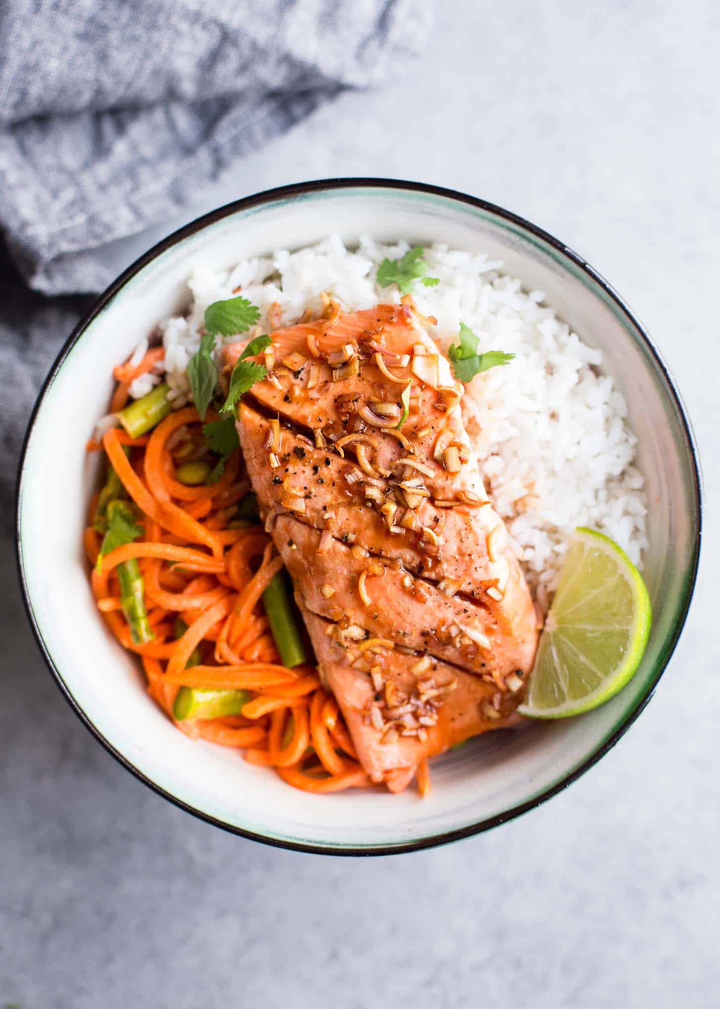 Salmon over rice in a white bowl