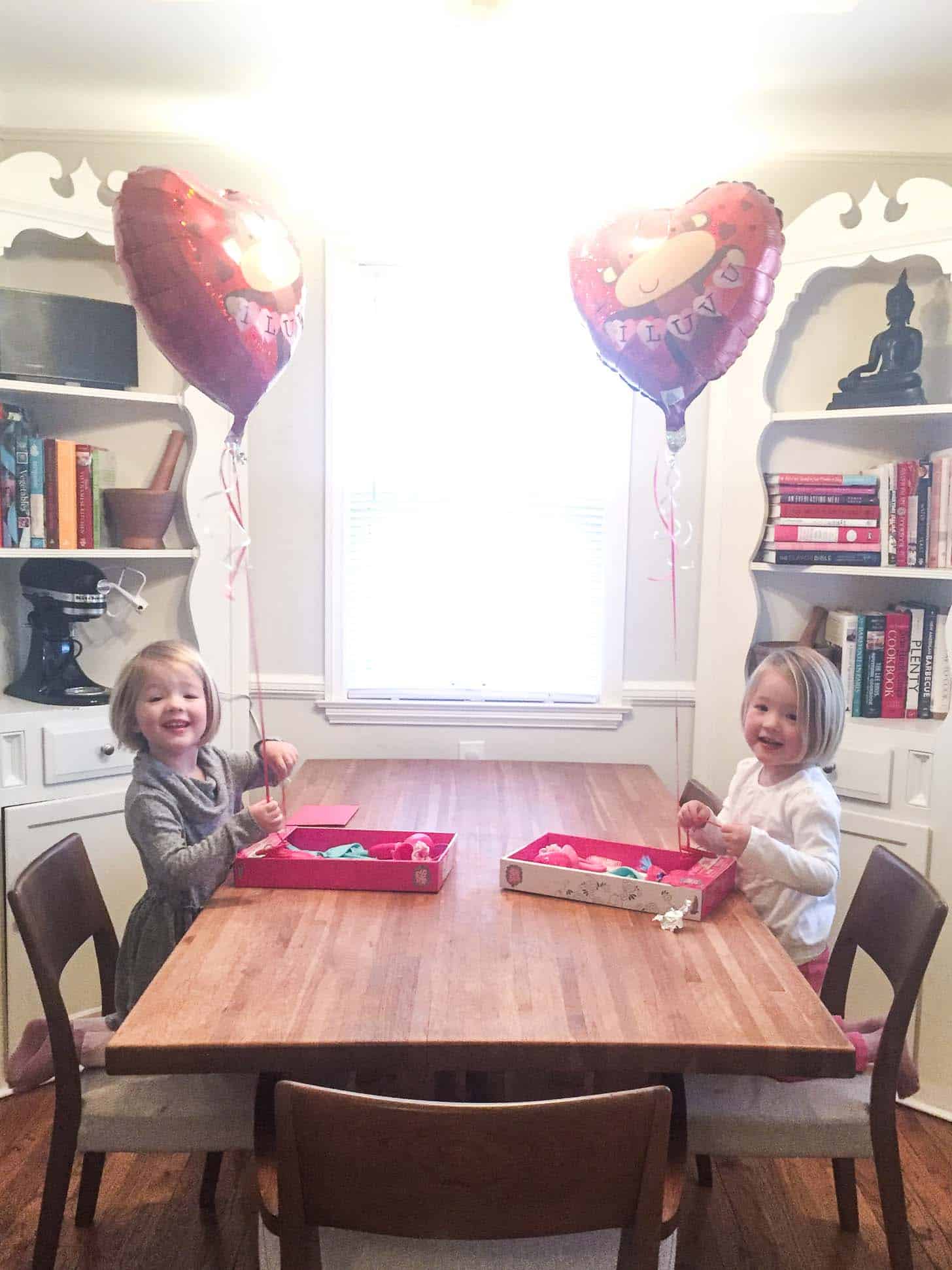 Molly and Clara with valentines and heart balloons
