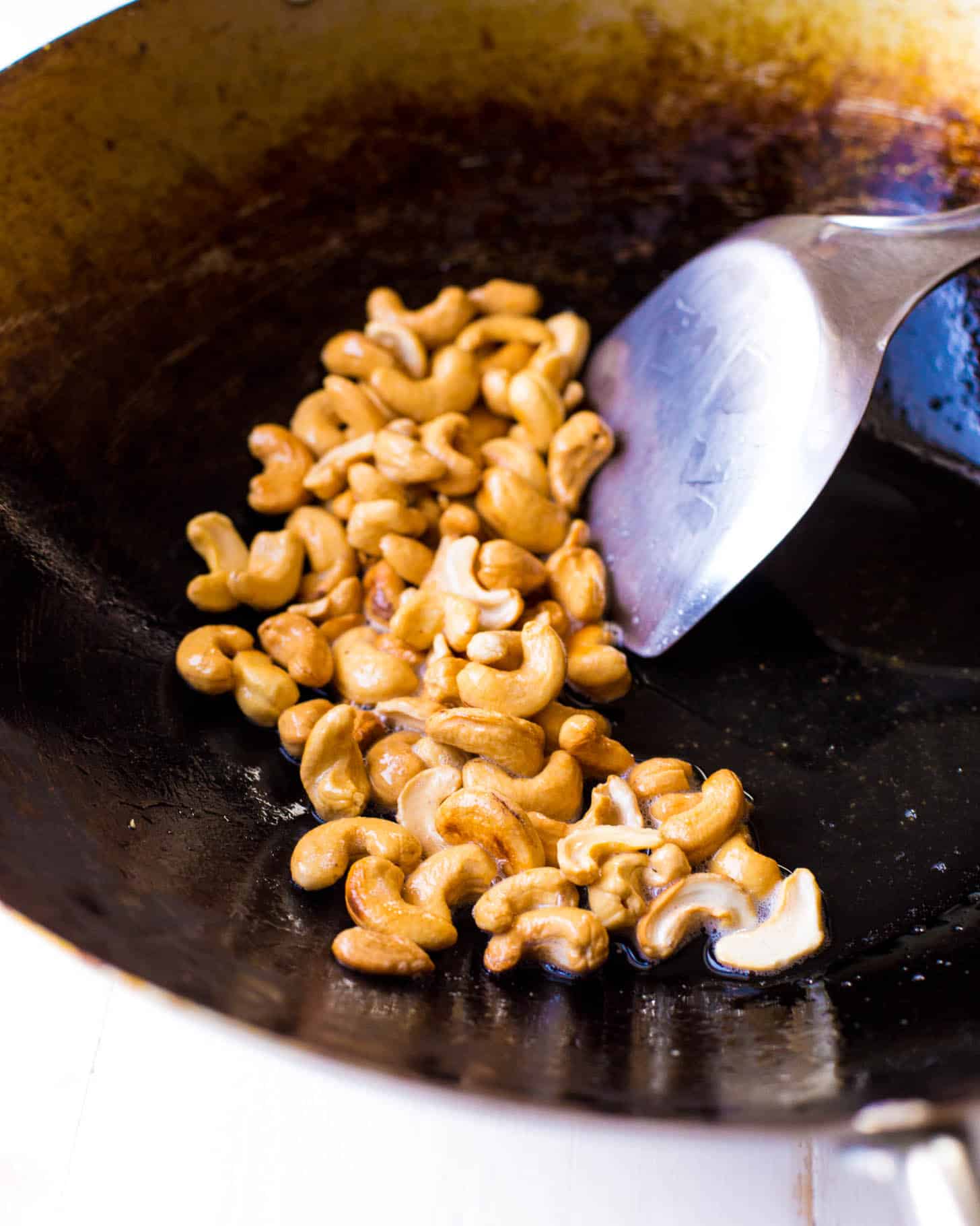 stirring cashews in a wok