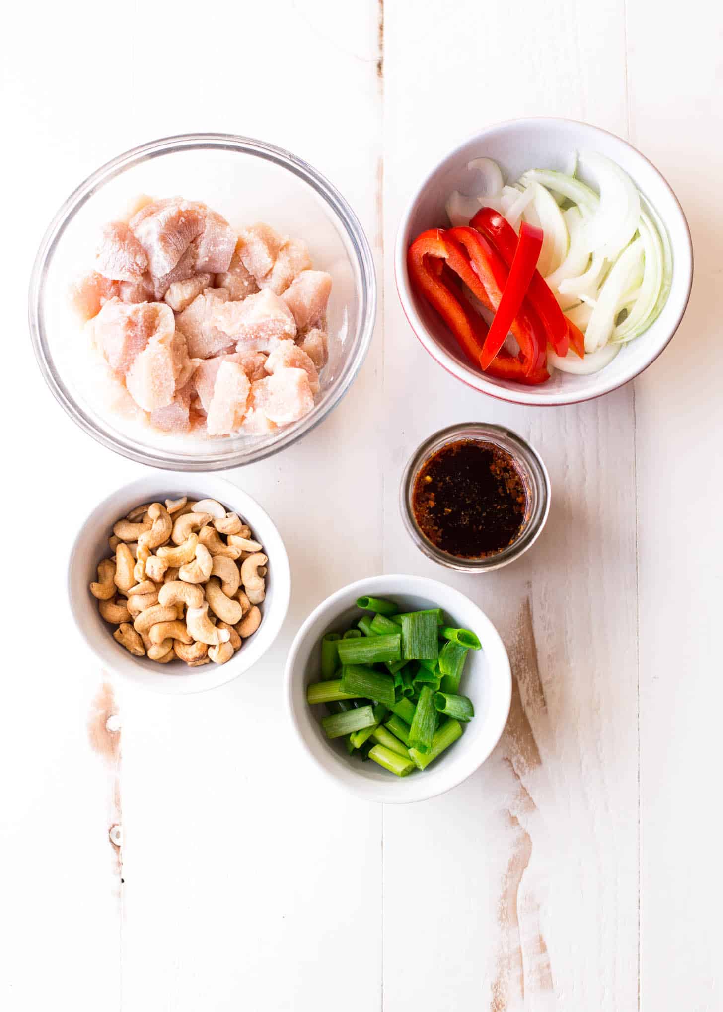 Thai Cashew Chicken ingredients  in small white bowls on a white table