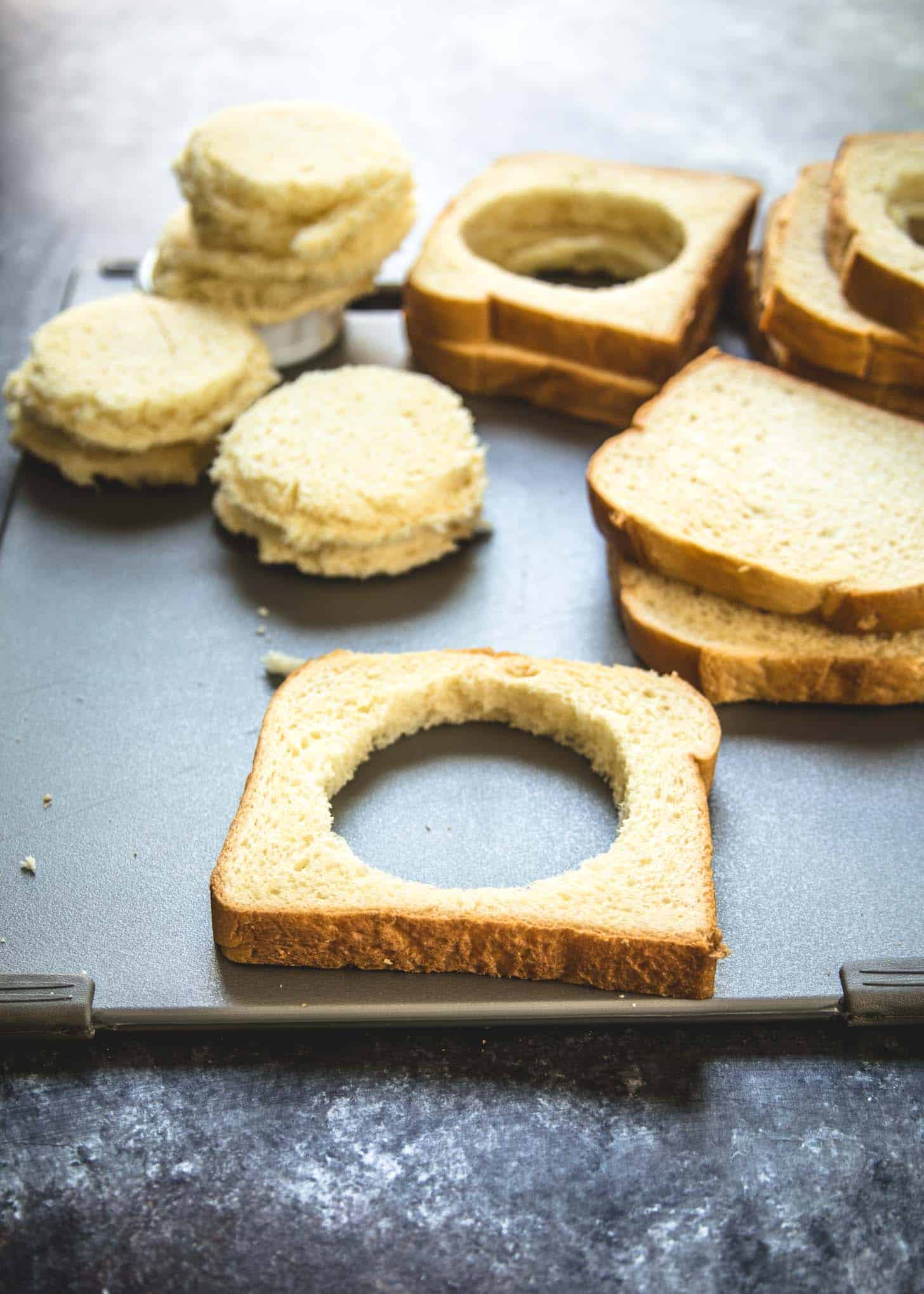 cutting holes in bread for eggs in a hole