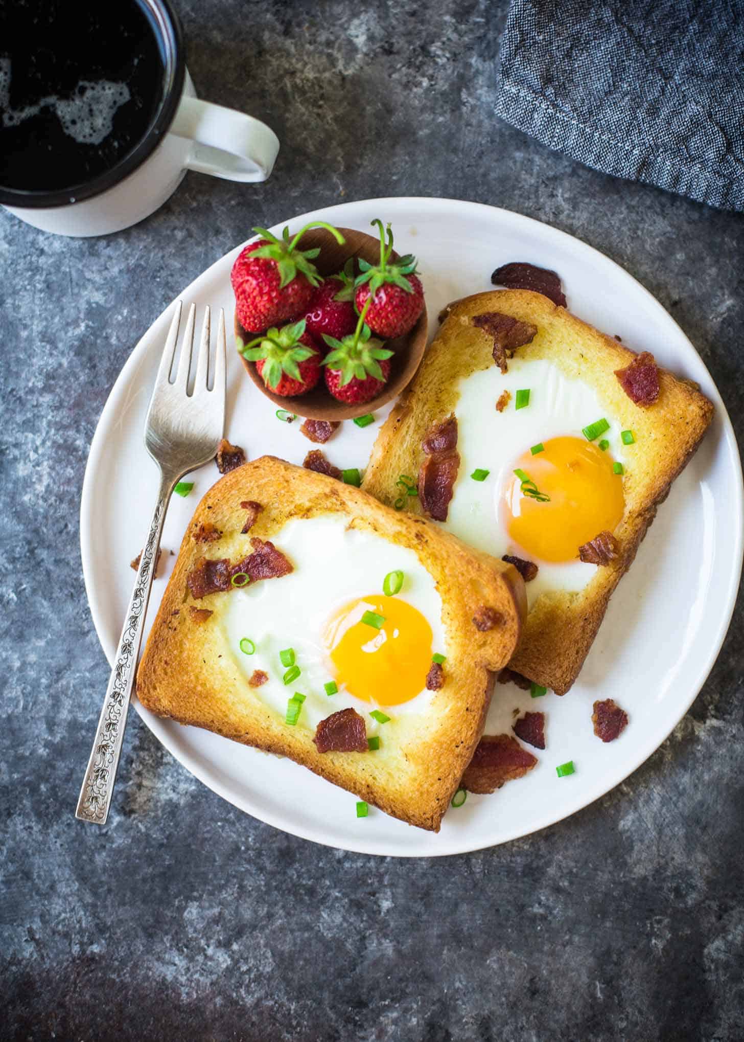 overhead image of toast with eggs on a white plate