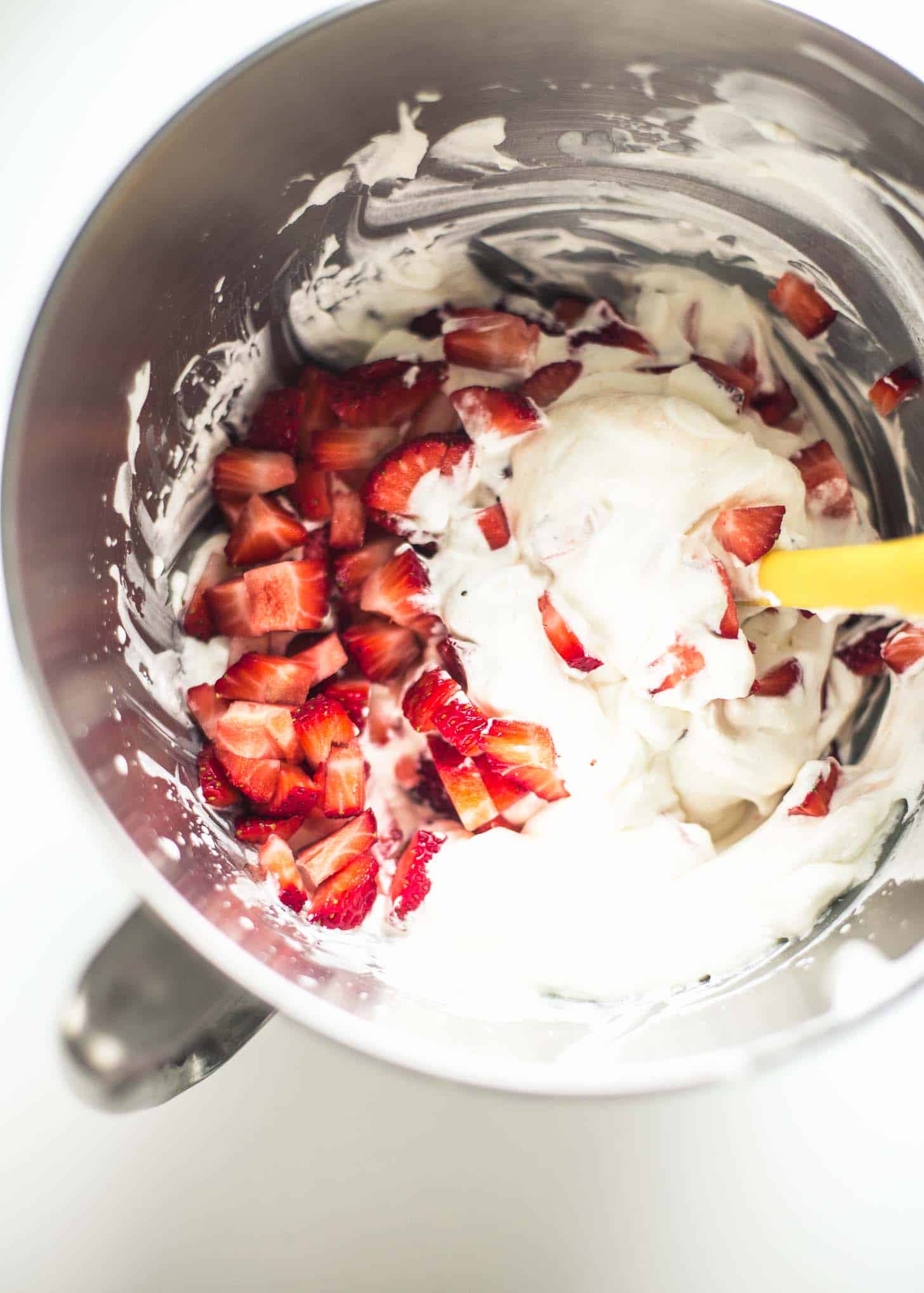 overhead image of mixing cream with strawberries