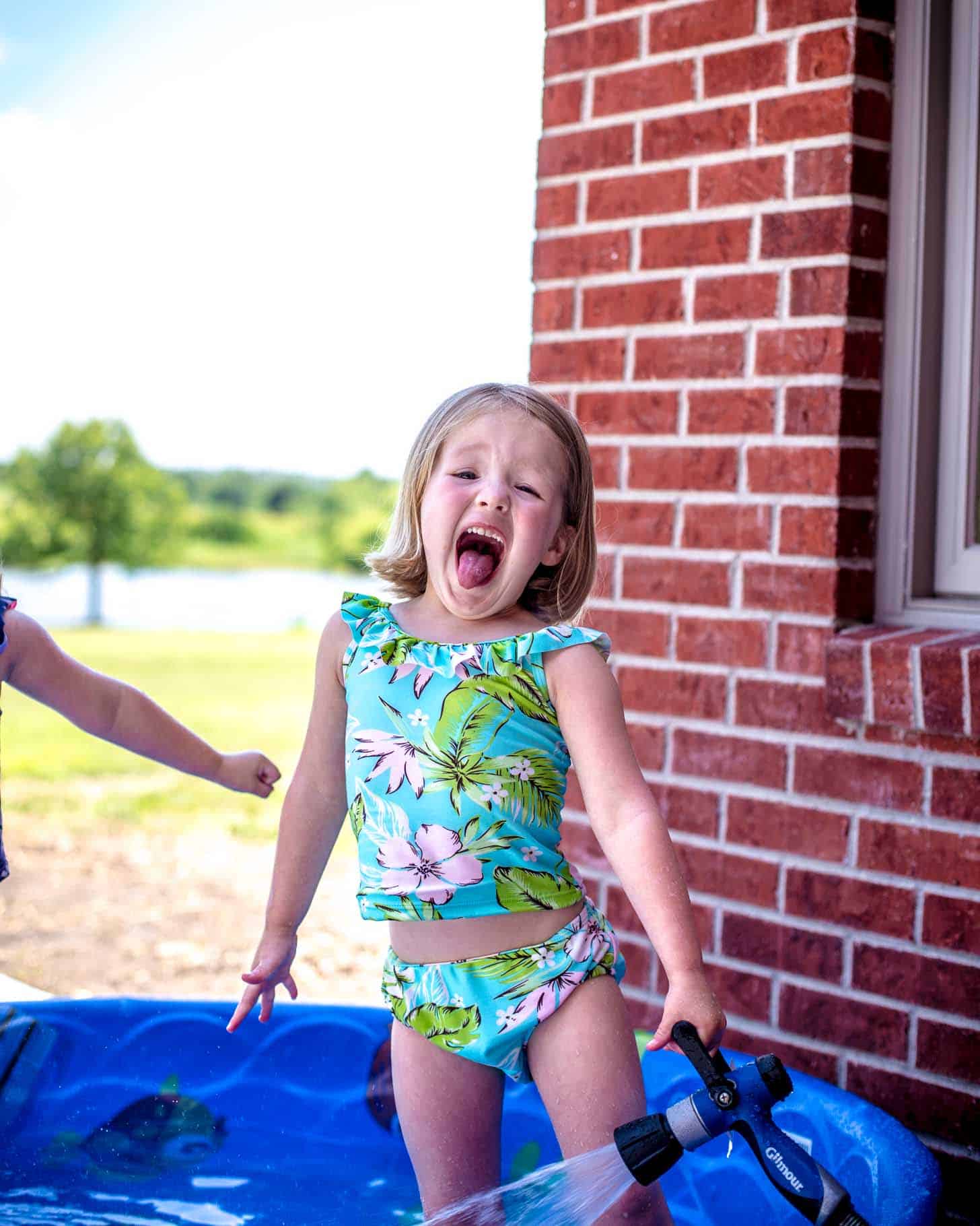 little girl playing in a baby pool