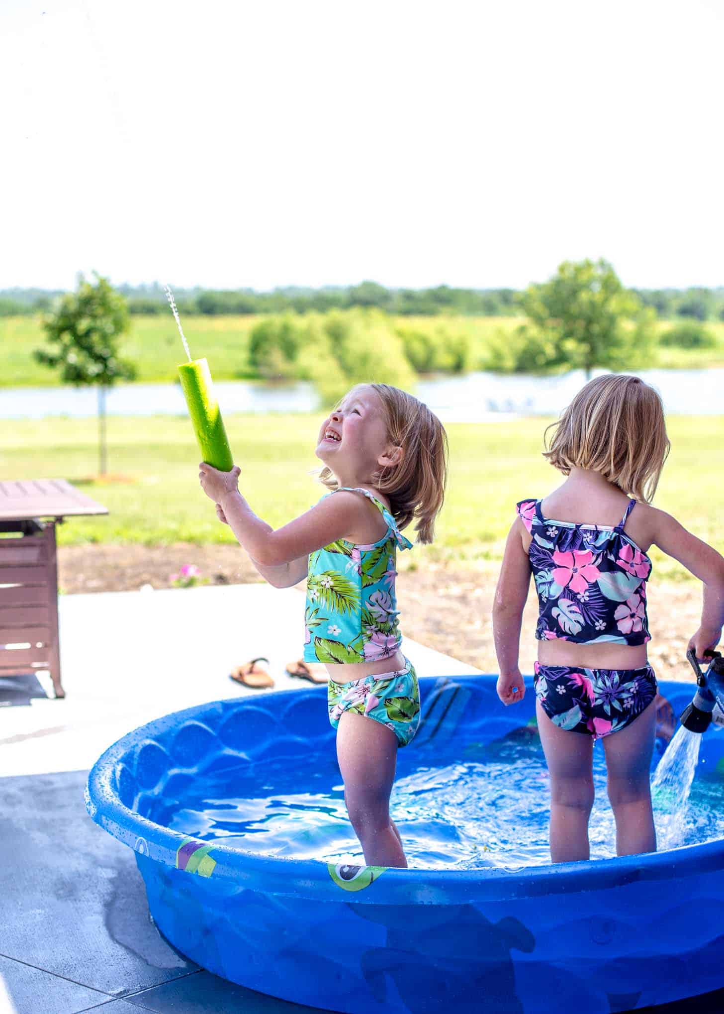 little girls playing in a baby pool