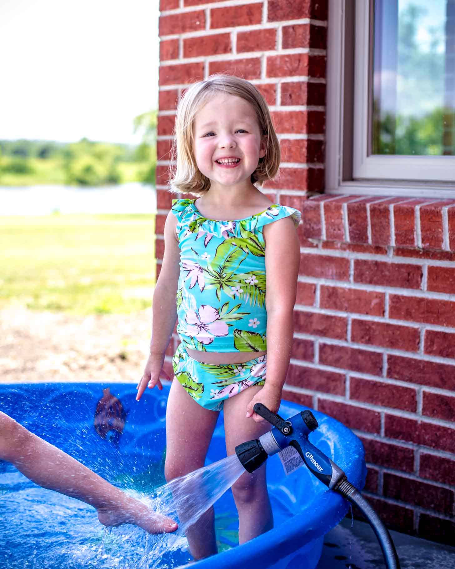 little girls playing in a baby pool