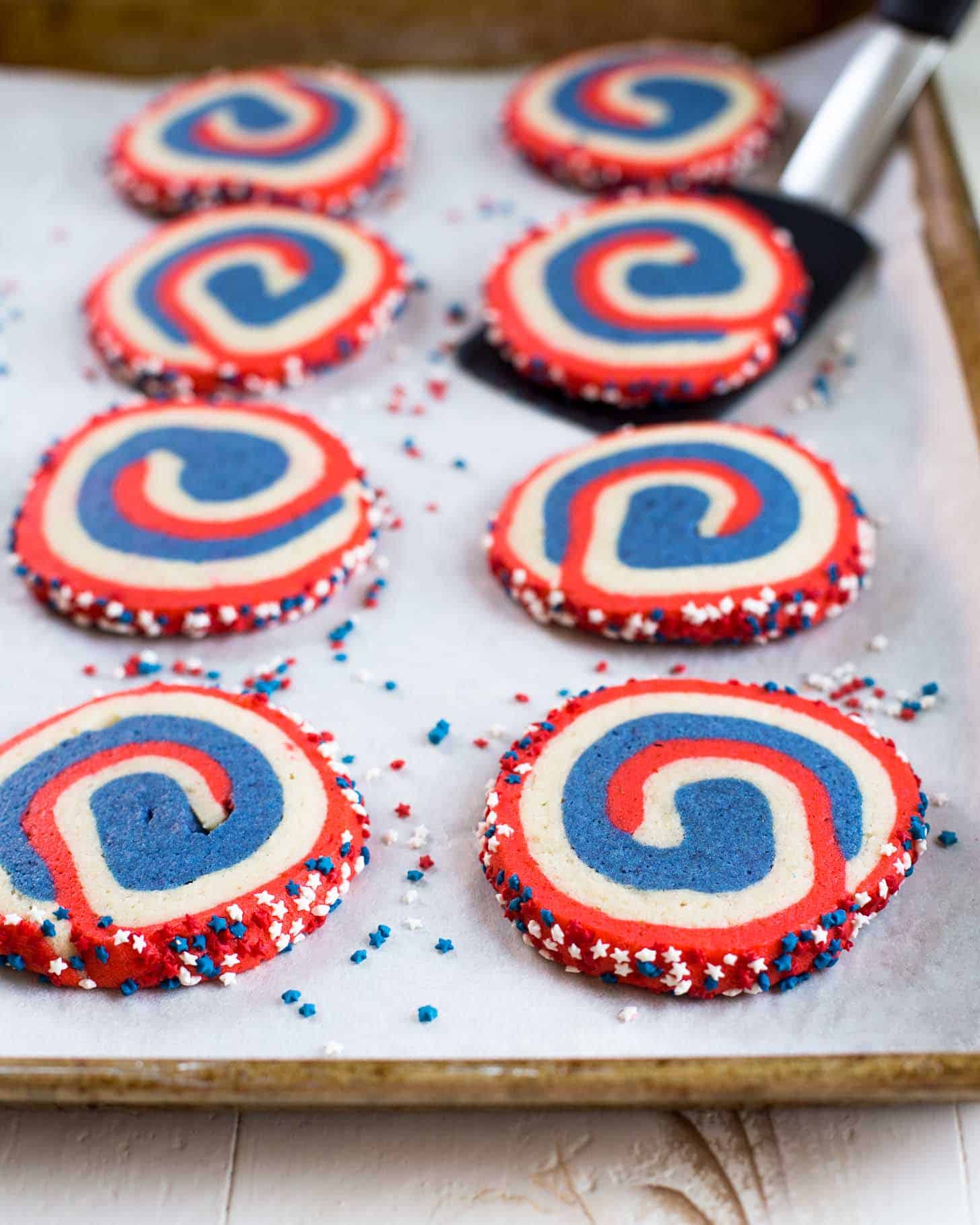 pinwheel cookies on a parchment lined sheet pan