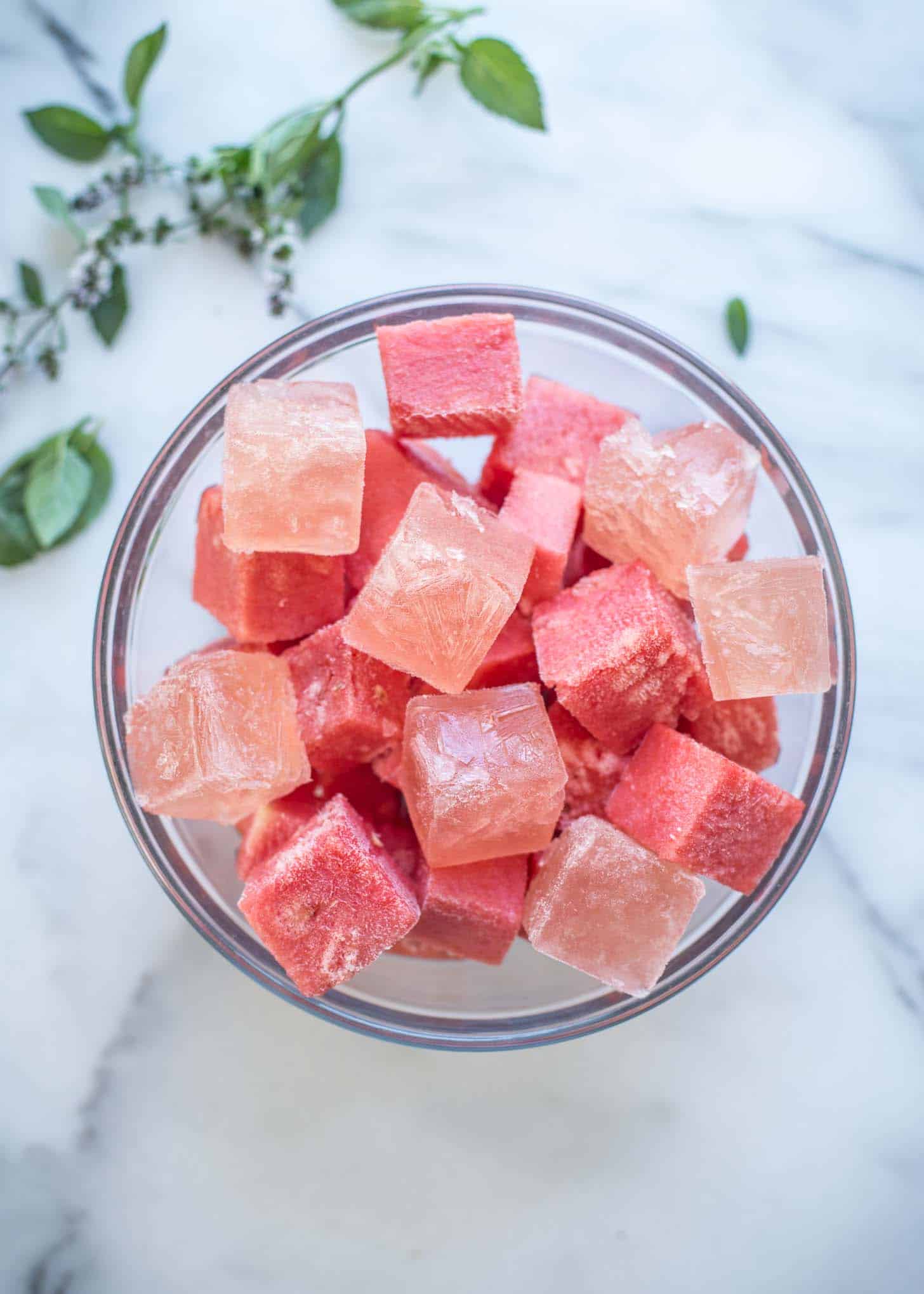 overhead image of cubed watermelon and white wine in a glass