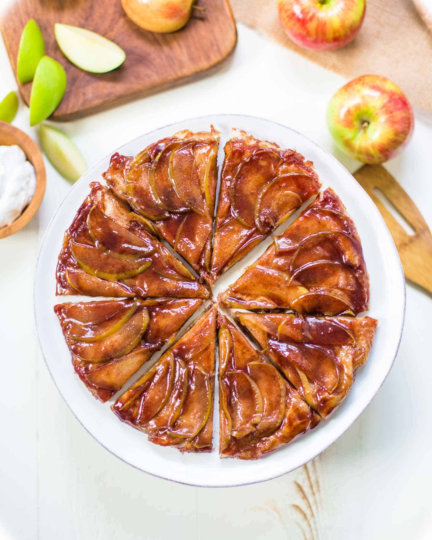 apple tart, cut into slices, on a white plate