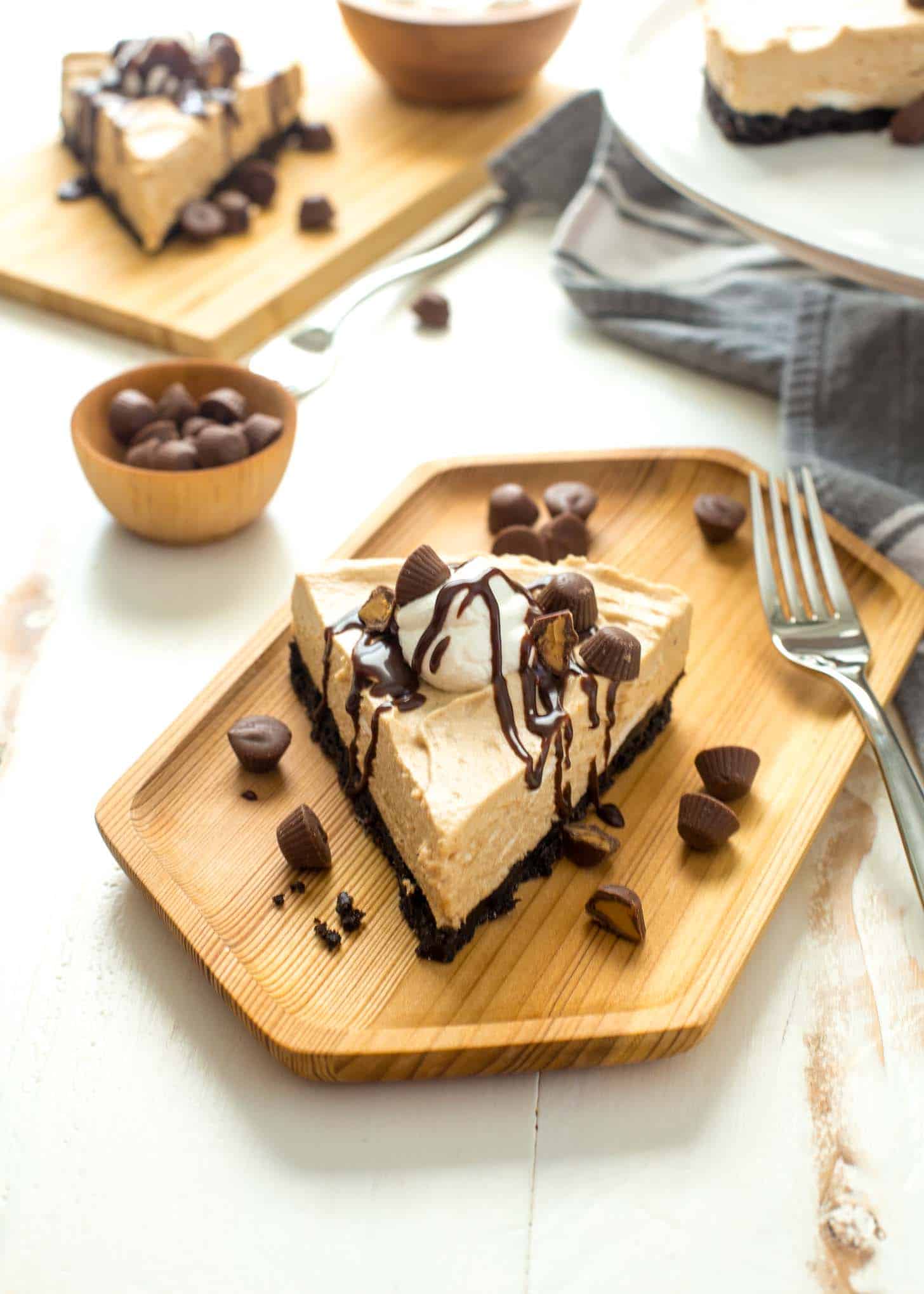 Frozen Peanut Butter Cheesecake Pie on a wooden tray