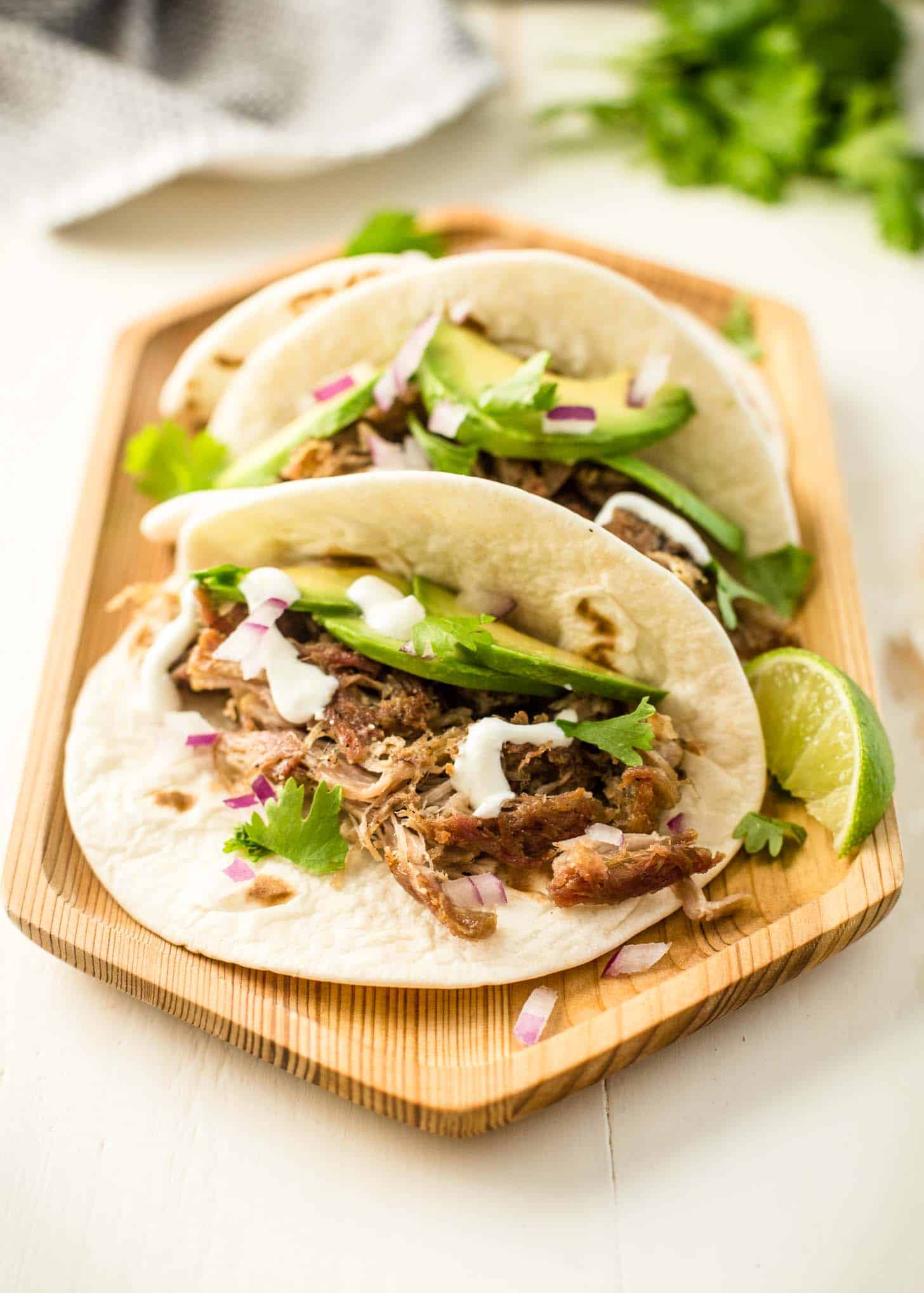  tacos on a wooden tray