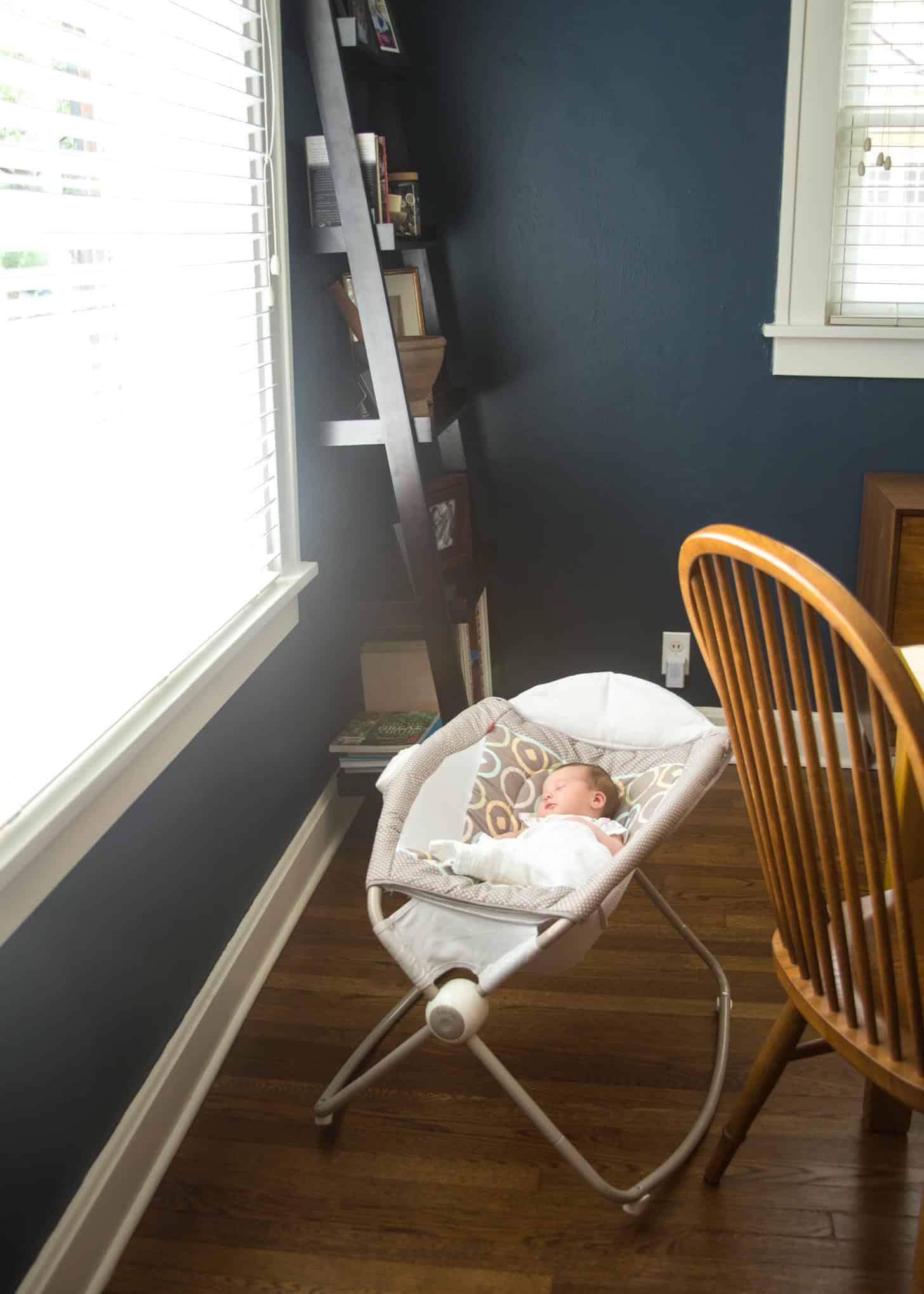 a baby sleeping in a swing