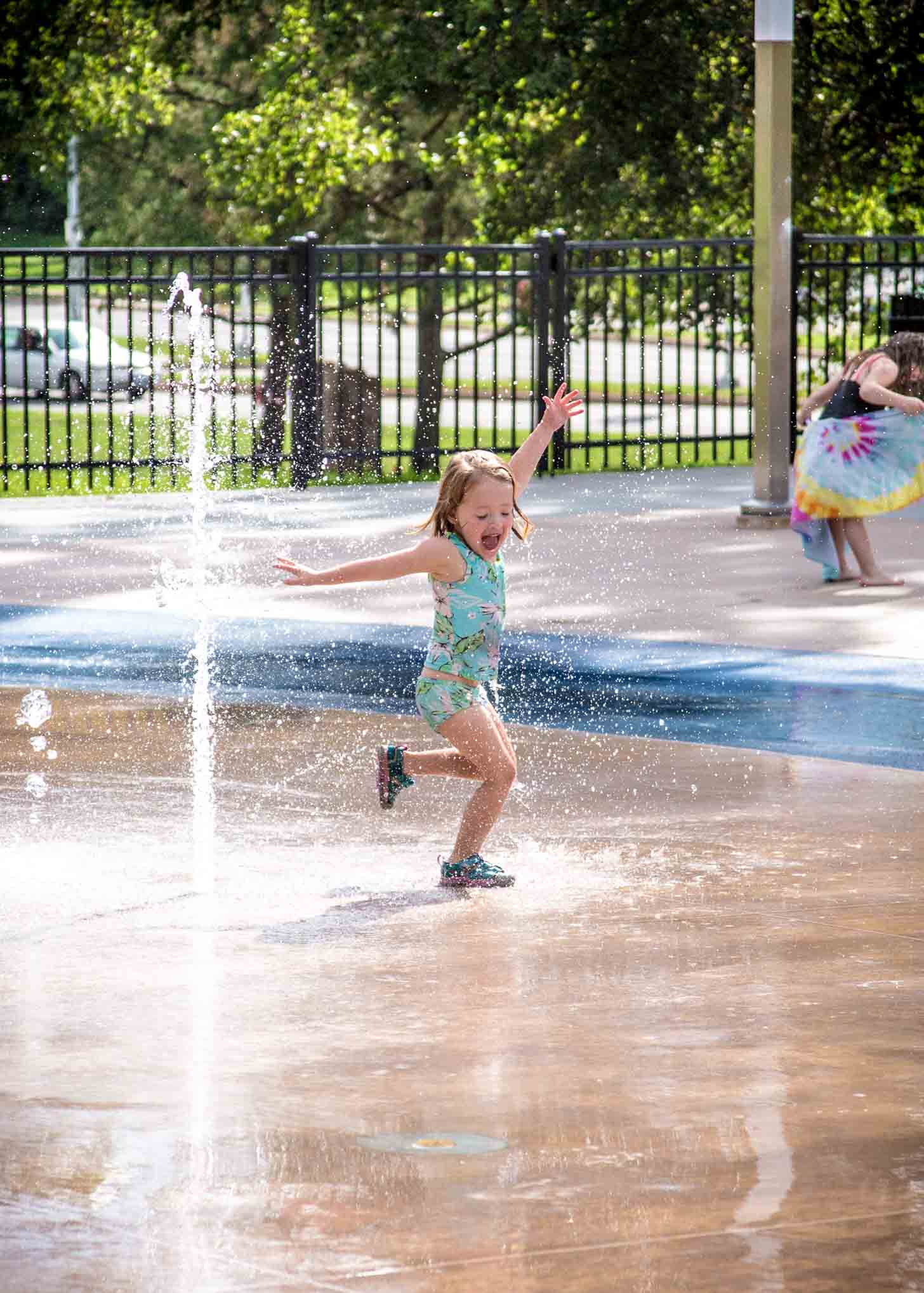 a little girl running through the water