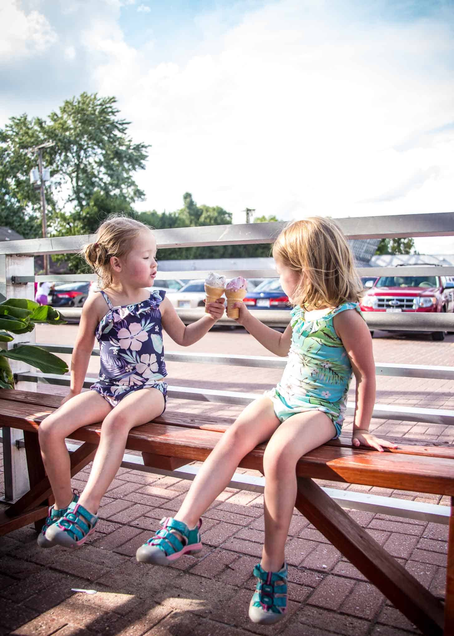 two little girls in bathing suits eating ice cream