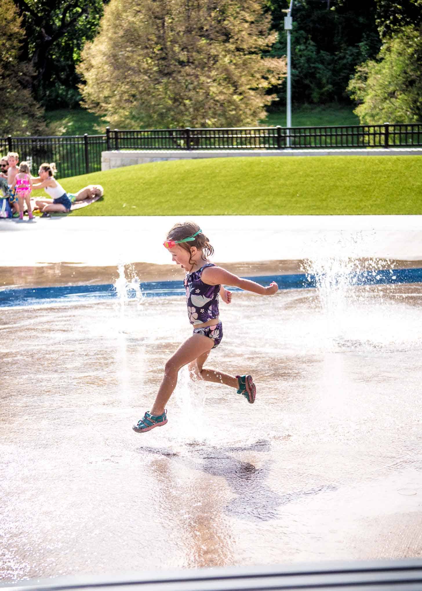 a little girl running through the water