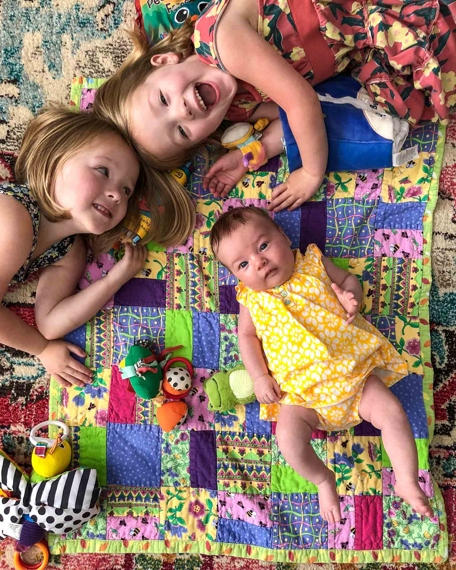 Molly, Clara and June on a play mat