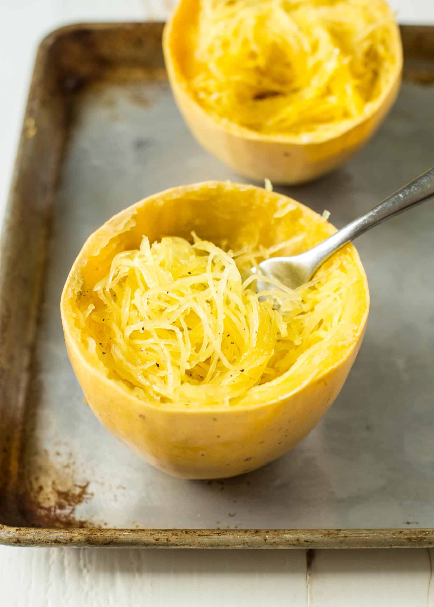 cooked spaghetti squash with a fork