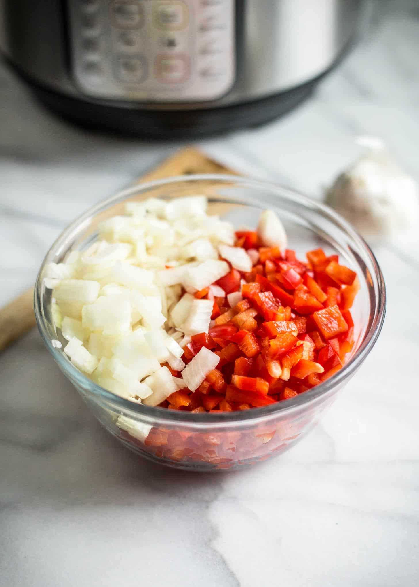 chopped Onions and peppers in a small clear bowl