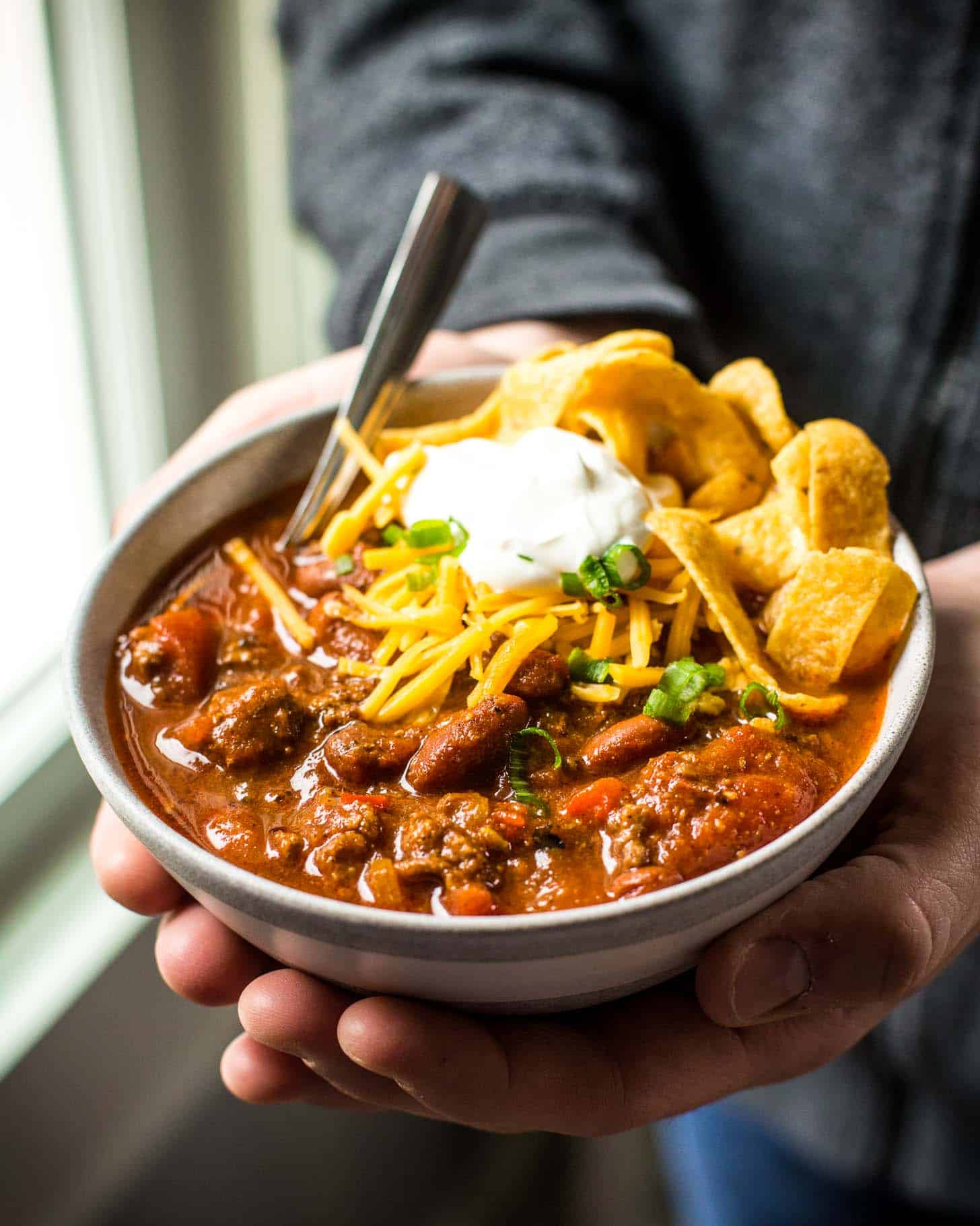 a bowl of Chili with cheese and sour cream