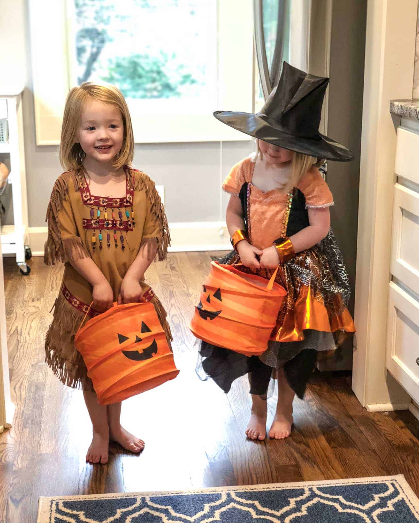 two little girls in halloween costumes