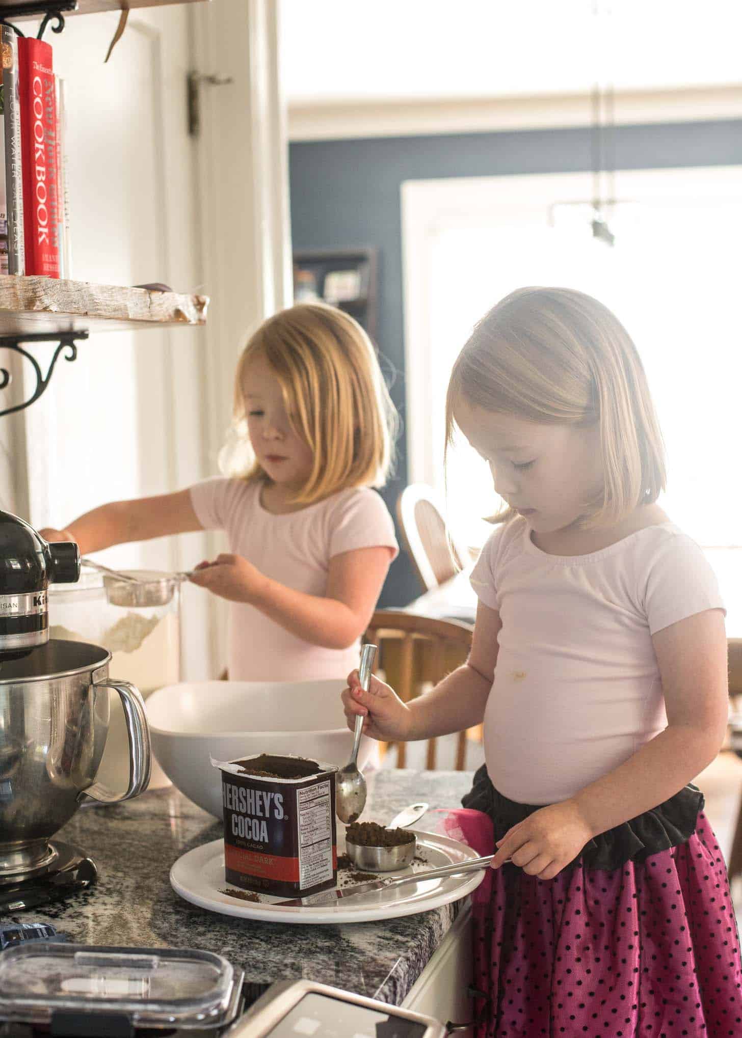 two little girls helping with baking cookies