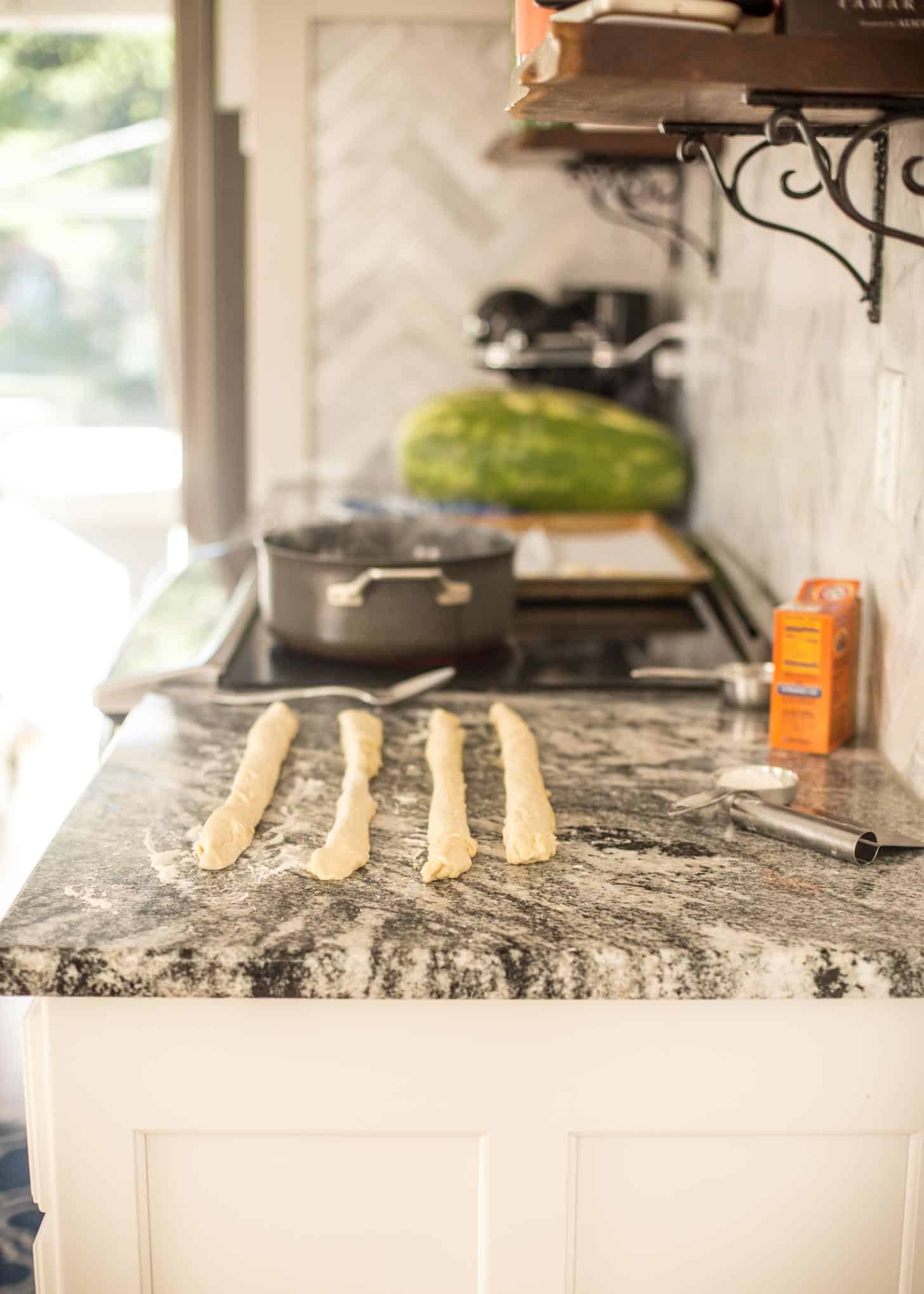 rolling dough on a marble countertop