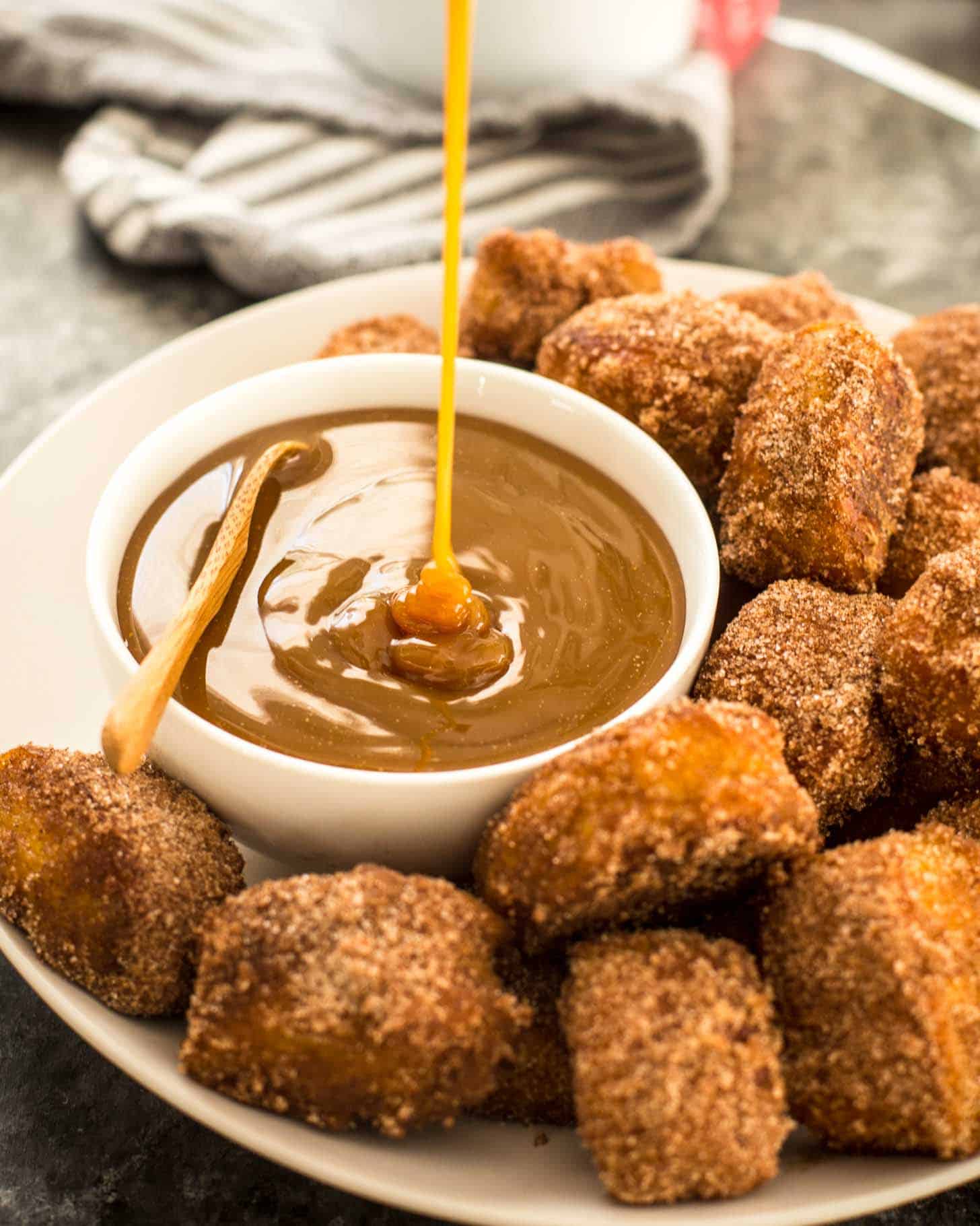 pouring dipping sauce into a small white bowl