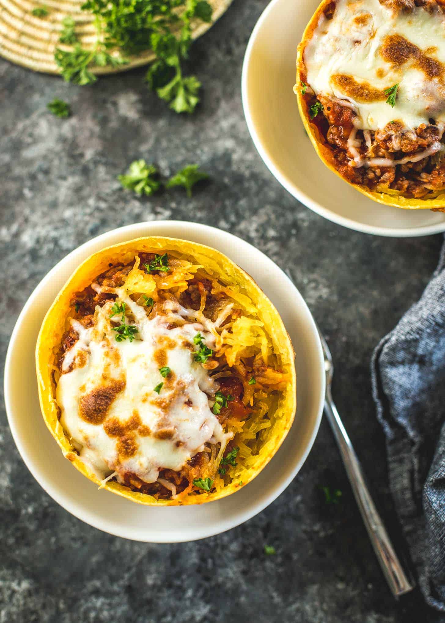 Spaghetti Squash Bowls with Marinara and Italian Sausage in white bowls