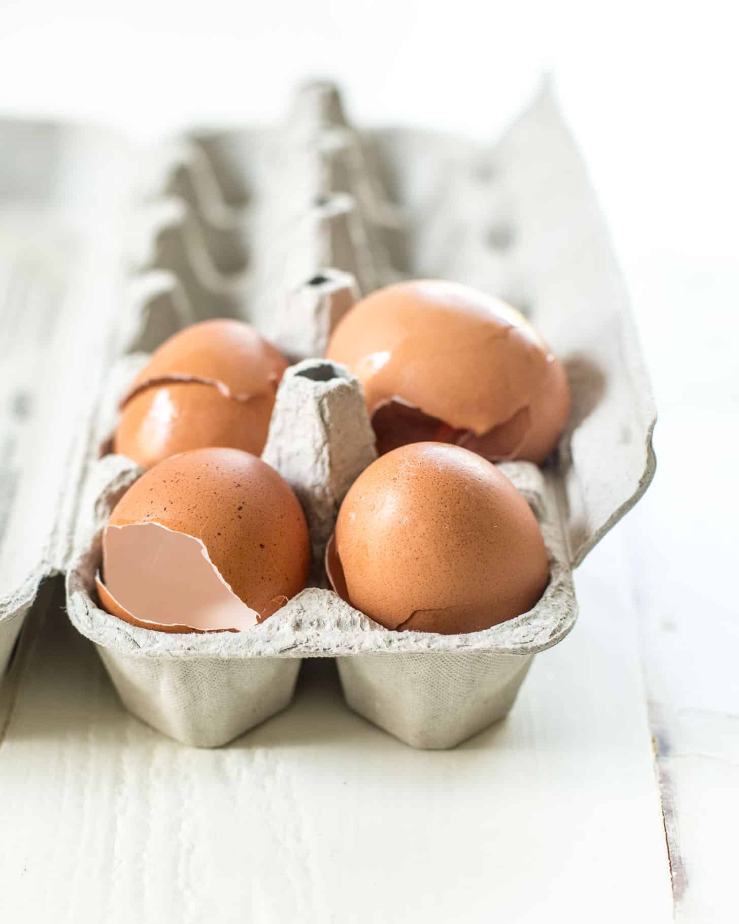 4 egg shells in a cardboard egg tray