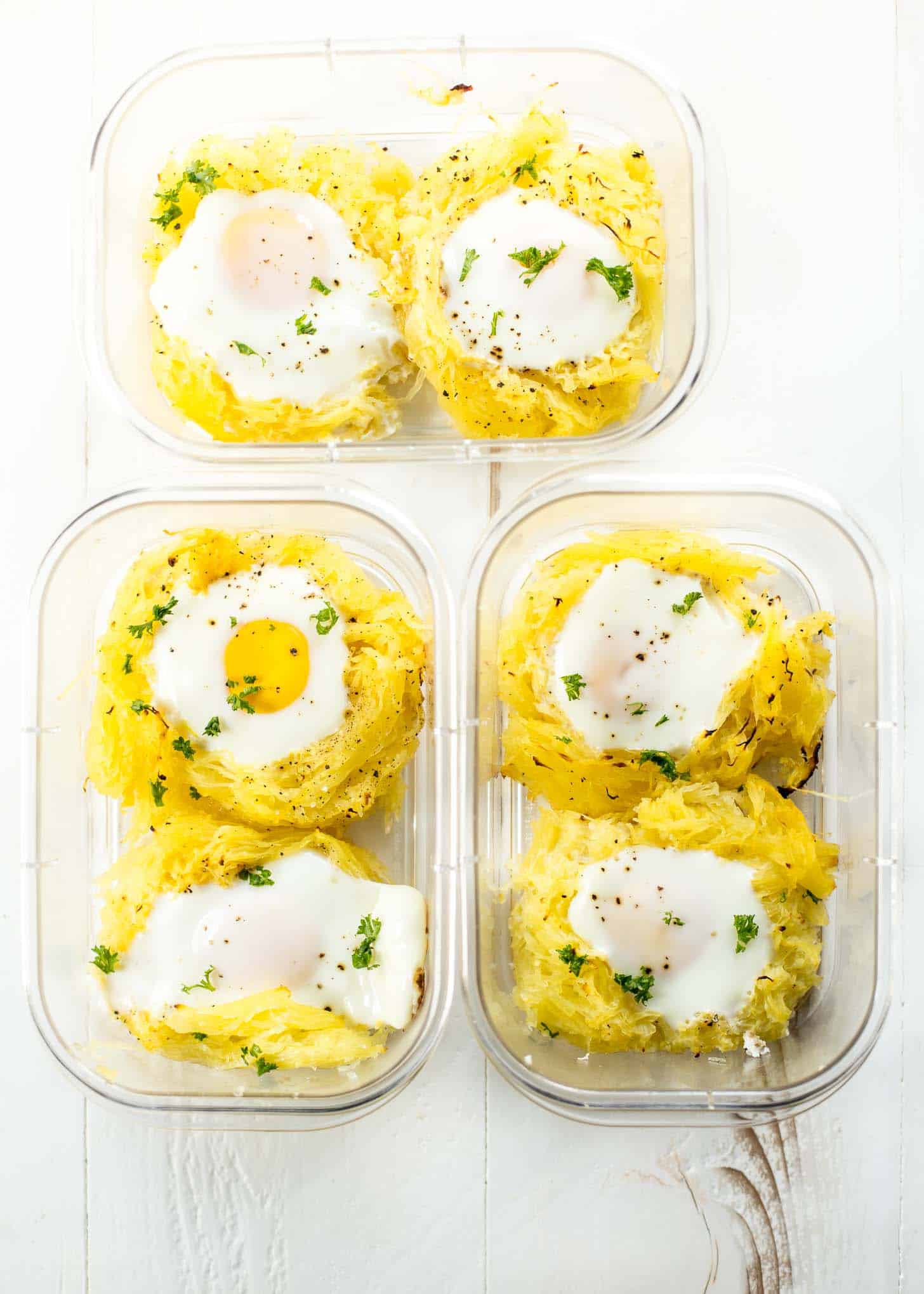 overhead image of glass containers with 2 cooked egg nests each