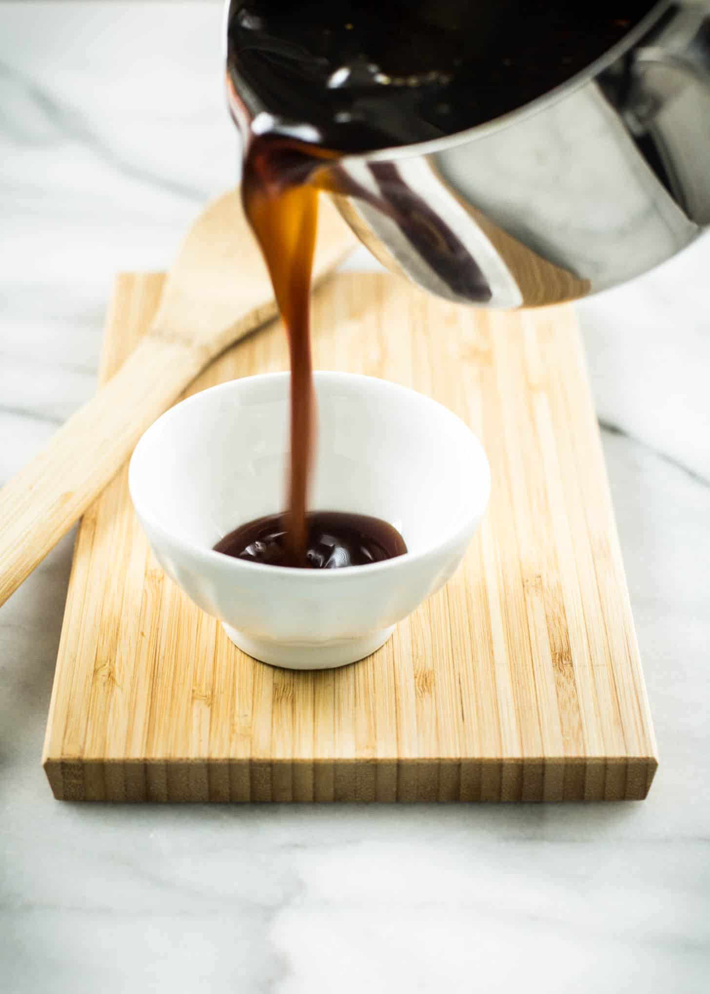 pouring sauce into a small bowl