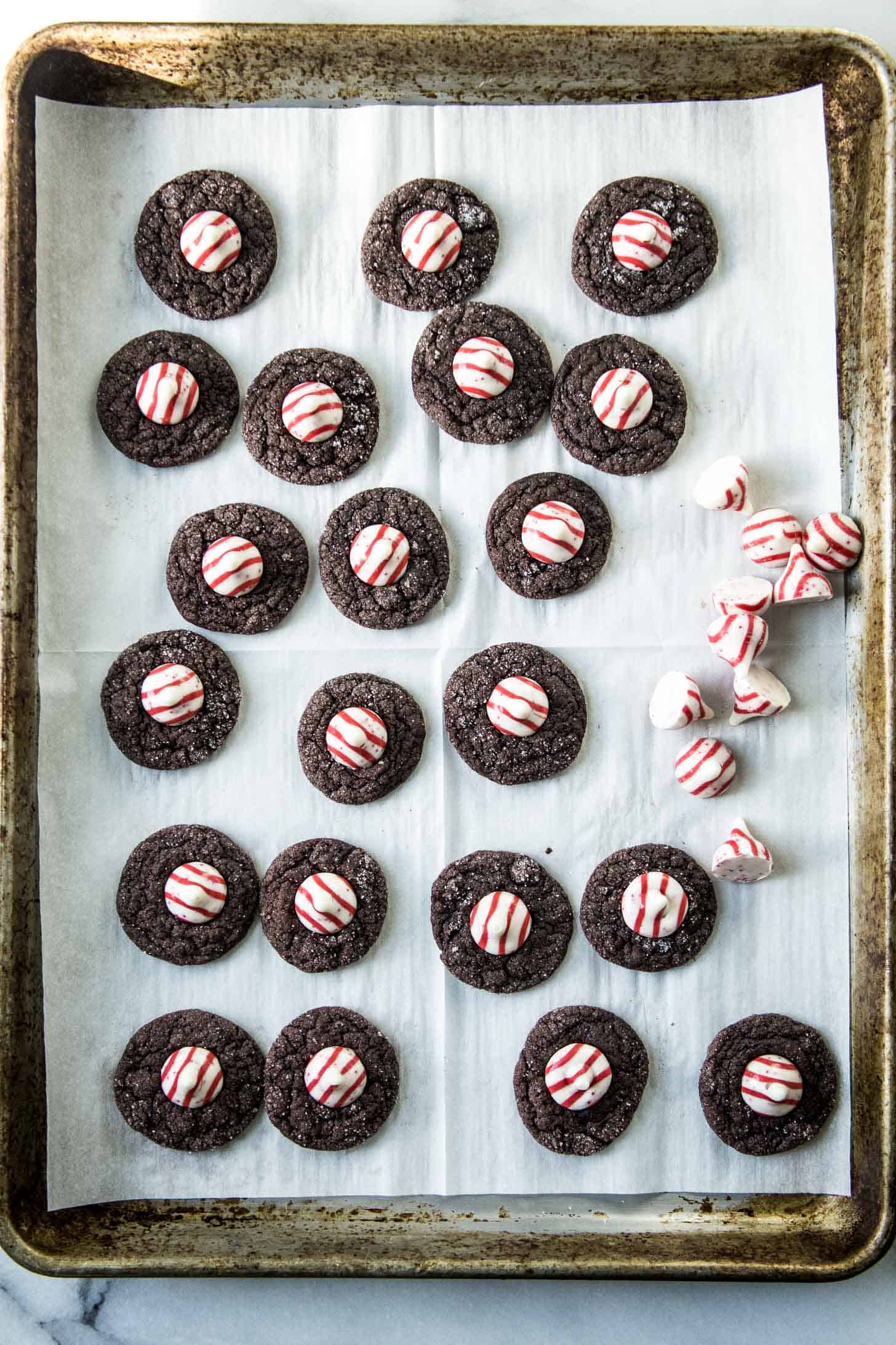 Chocolate Peppermint Blossoms on a parchment lined sheet pan