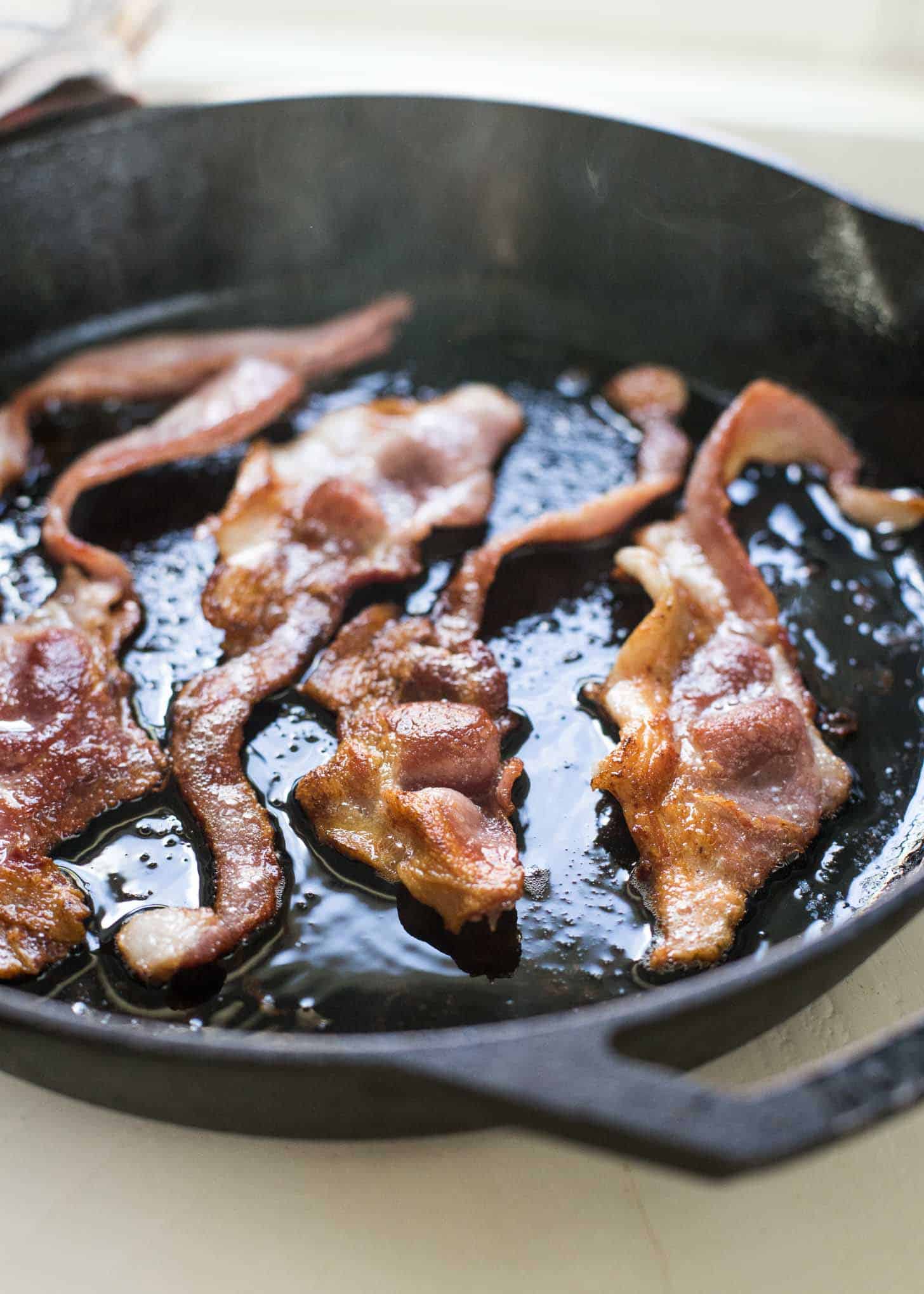 cooking bacon in a cast iron skillet