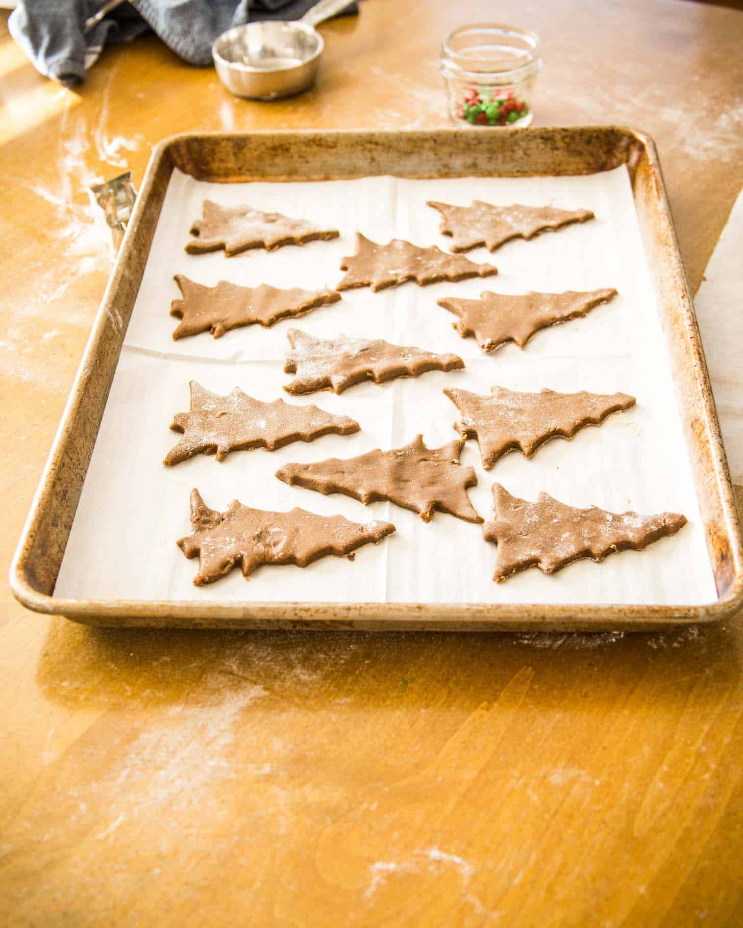 raw Gingerbread Cookies on a parchment lined sheet pan