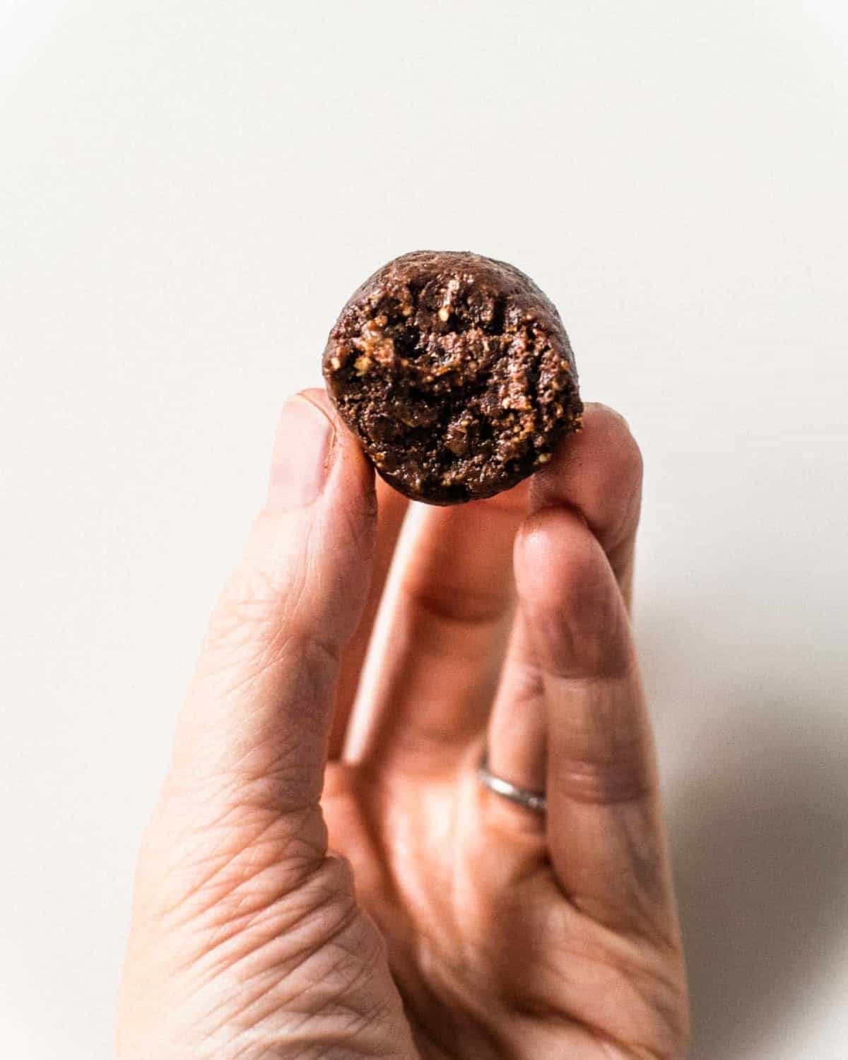 a hand holding Chocolate Almond Energy Bites
