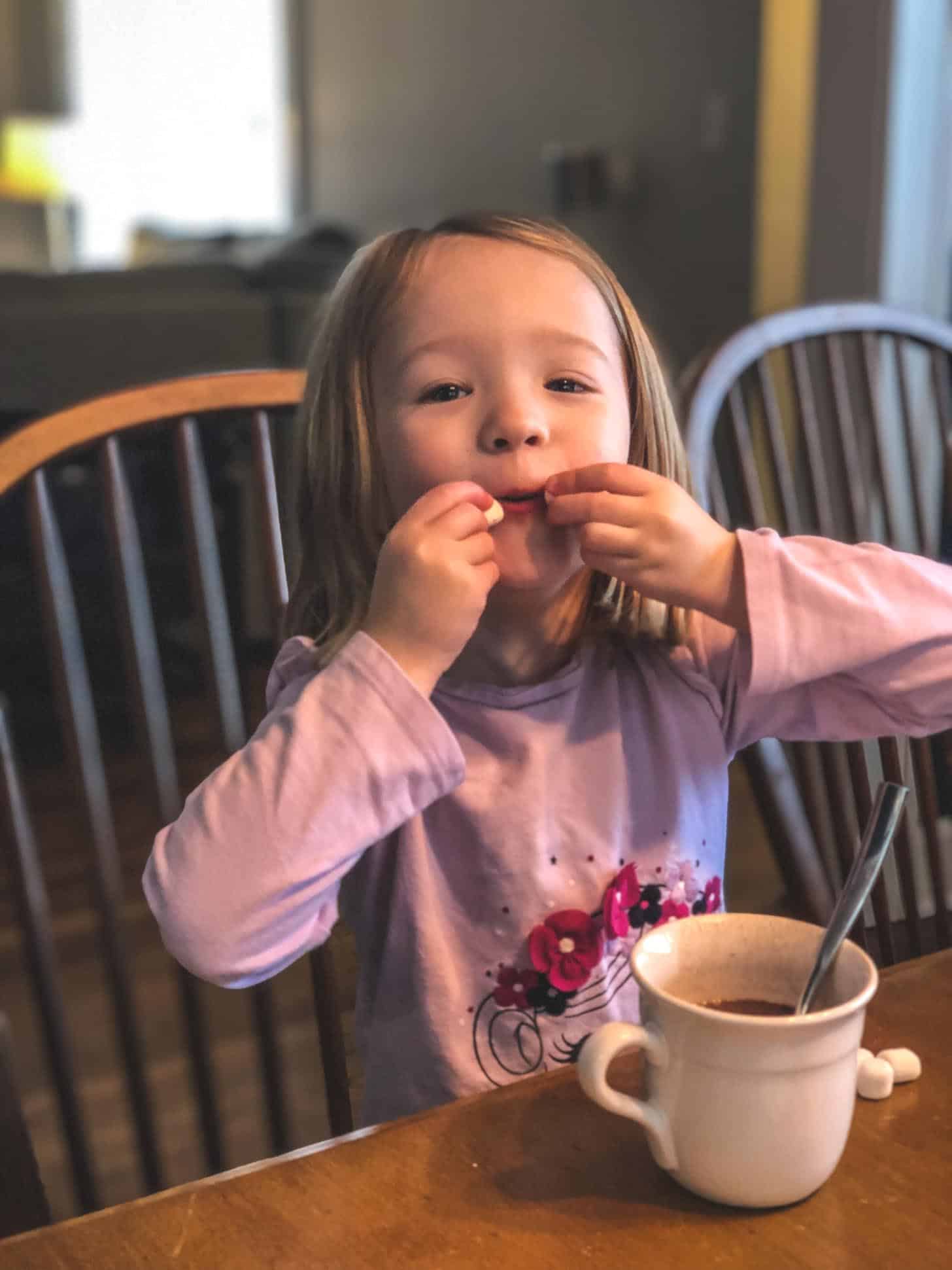 little girl with hot chocolate