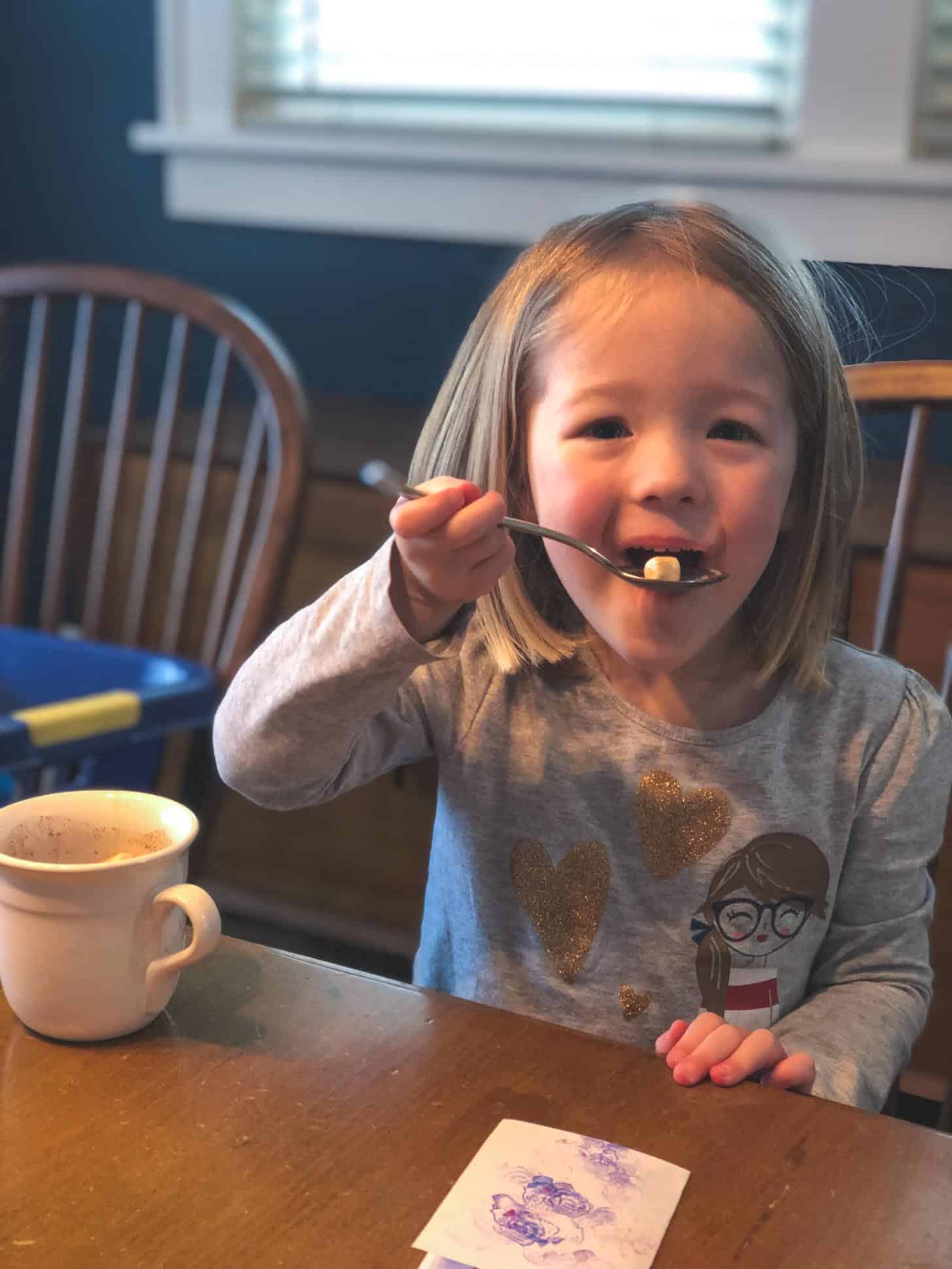 little girl with hot chocolate