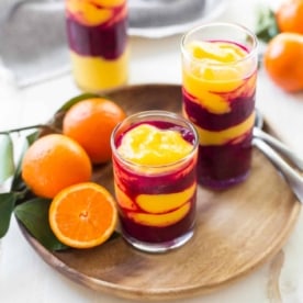 Mango Pitaya and Turmeric Smoothies on a wooden tray