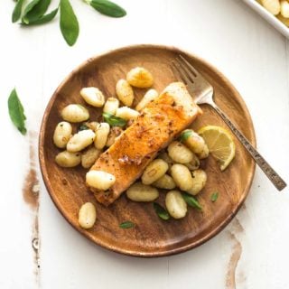 salmon and gnocchi on a wooden plate