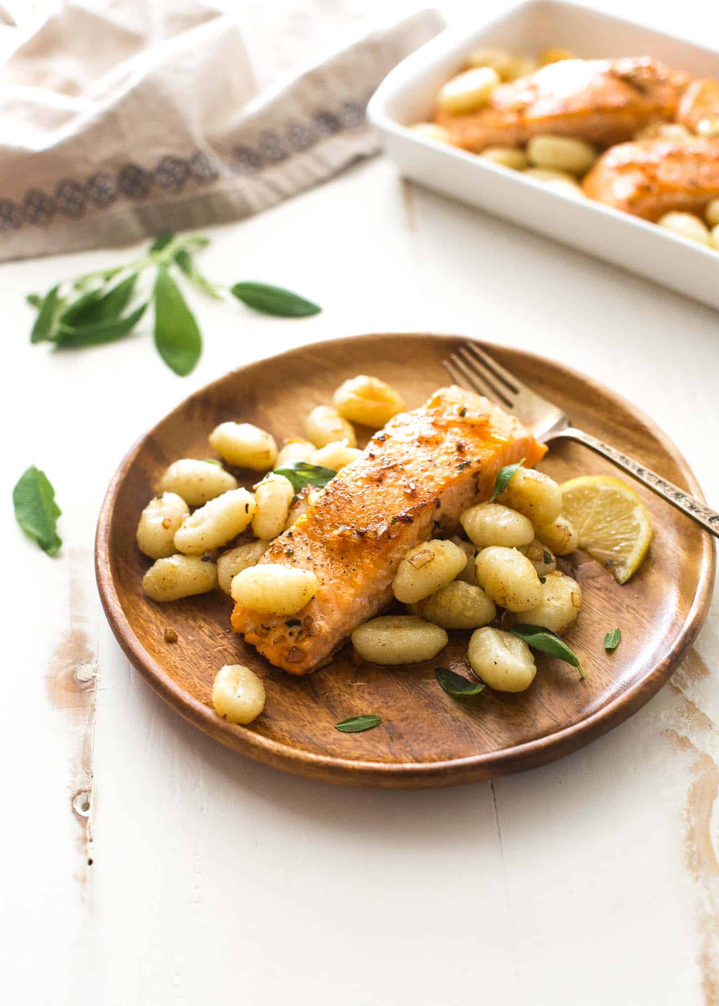 salmon and gnocchi on a wooden plate