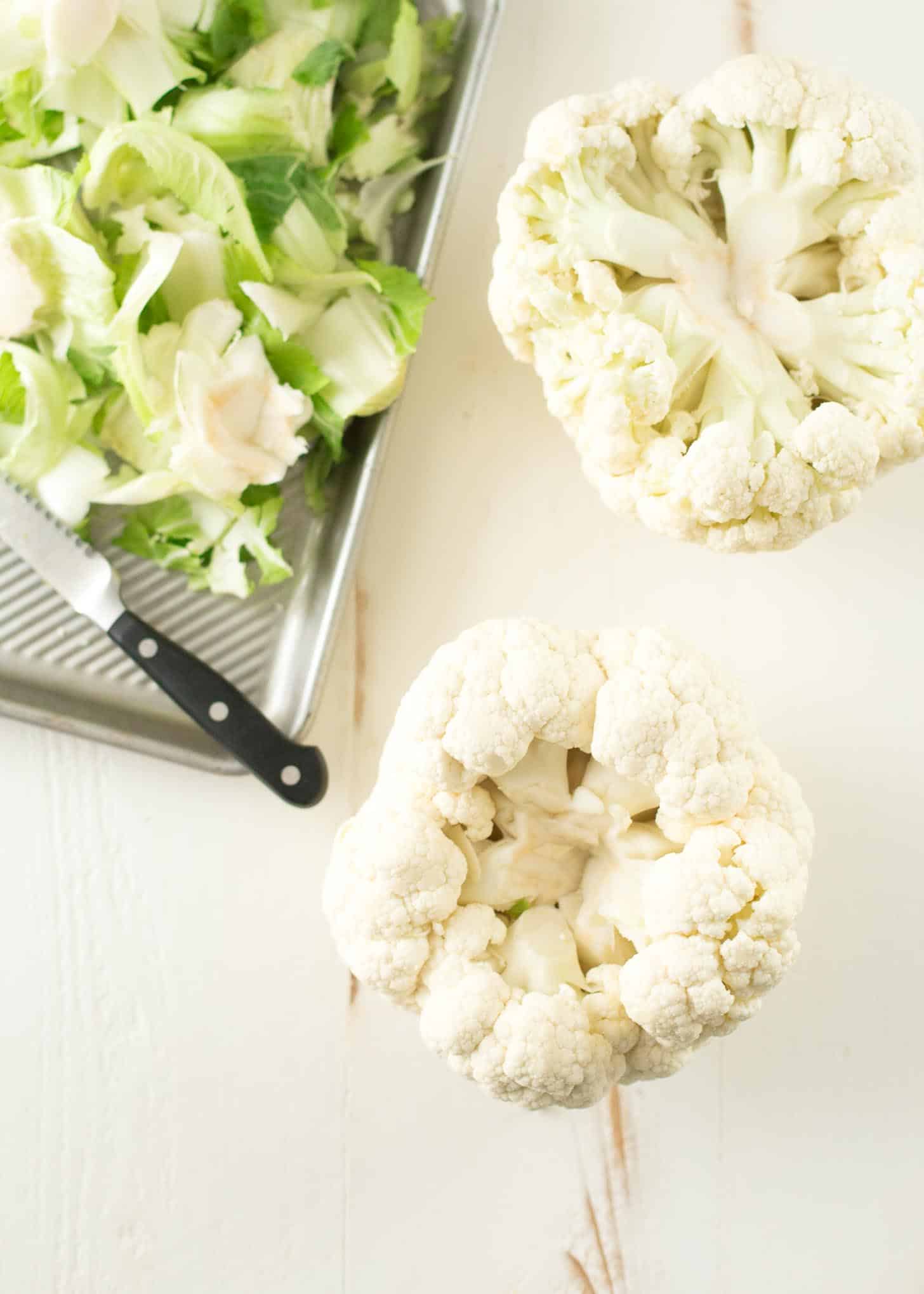 overhead image of a head of Cauliflower on a white table