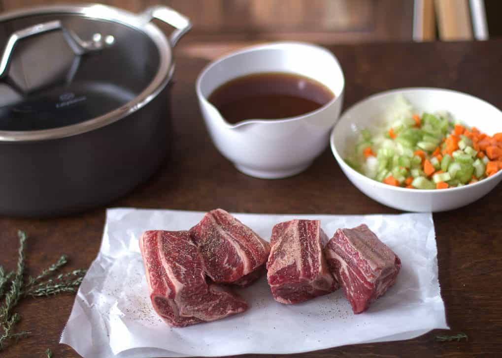 short ribs, red wine, and vegetables on a tabletop