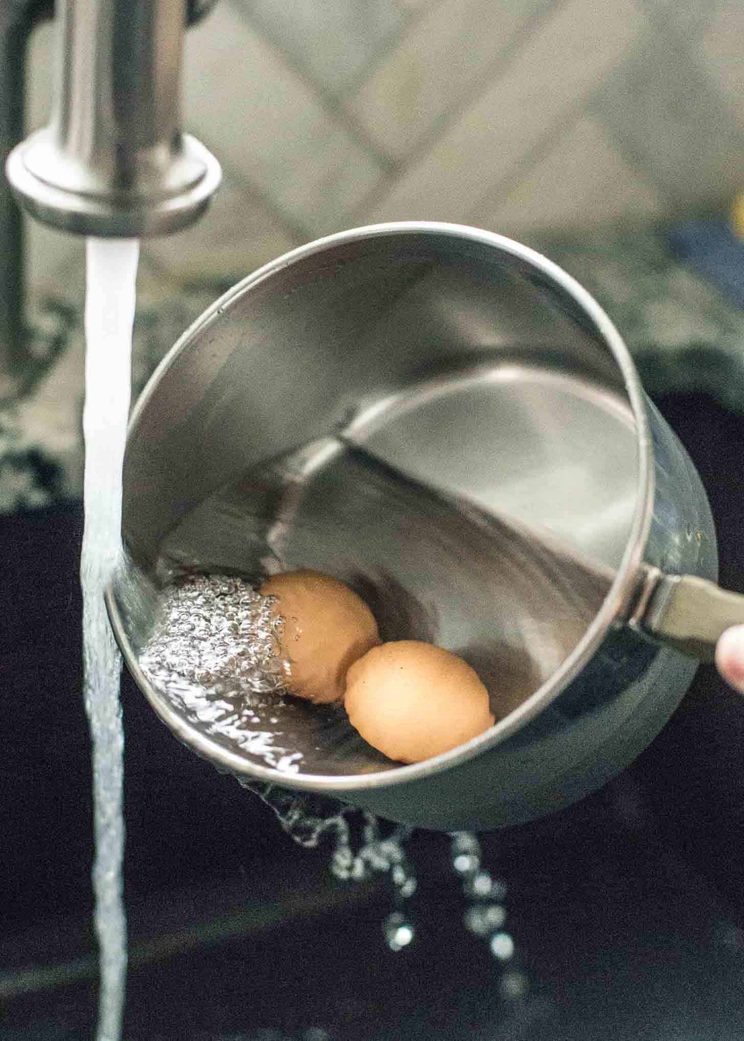 rinsing eggs in a saucepan