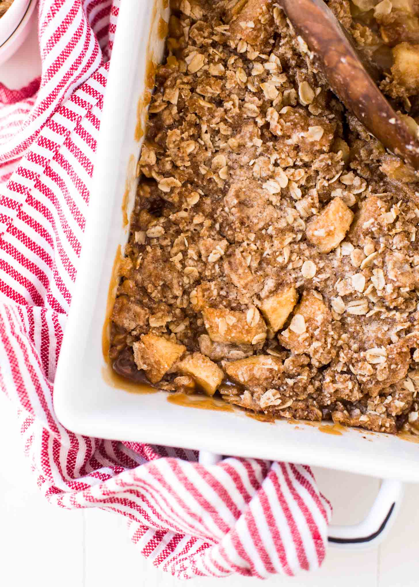 overhead image of apple crumble in a white baking dish