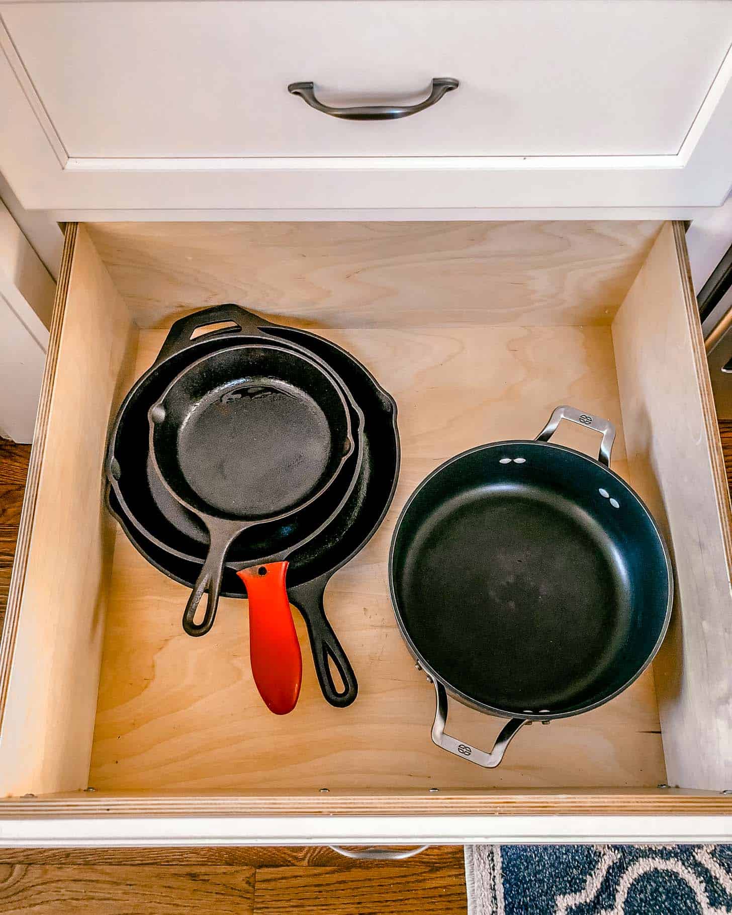 a large drawer with pots and pans