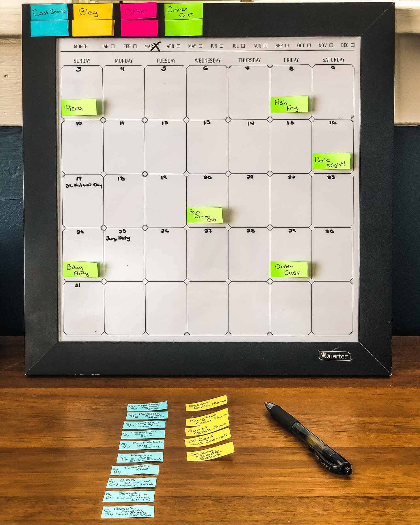 a dry erase calendar with colored paper strips